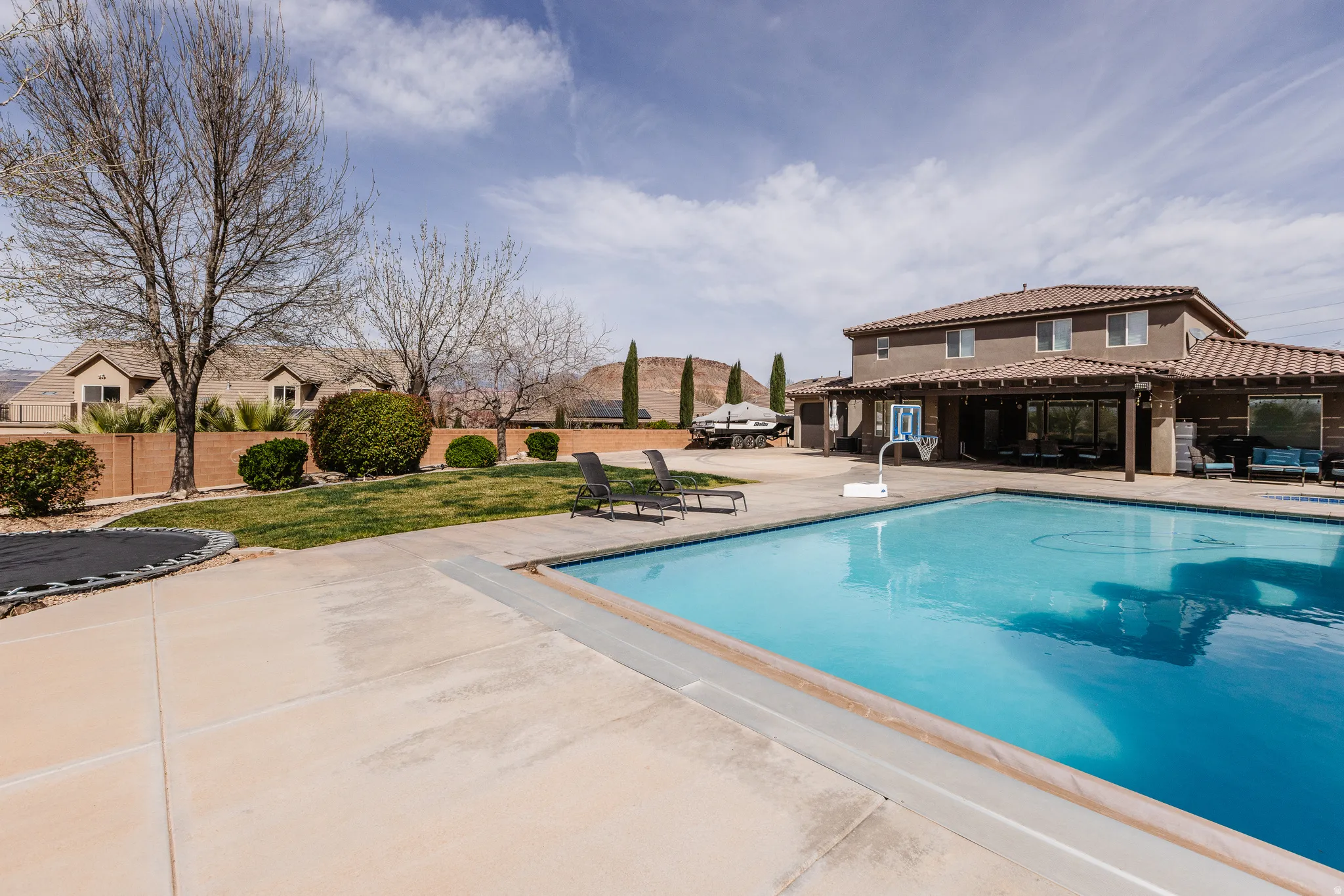 View of pool featuring patio surround, a pergola, and a residential view