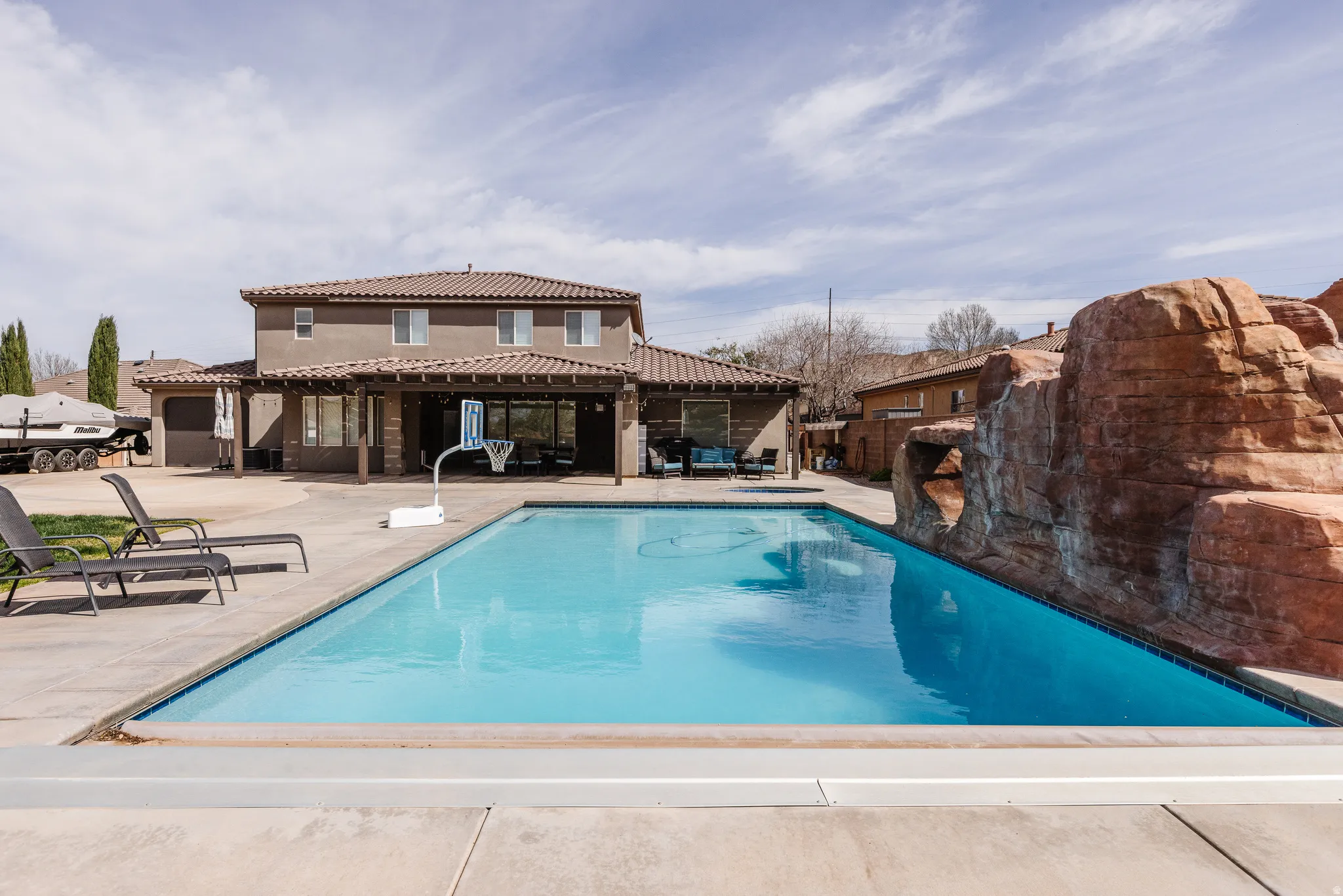 View of pool featuring patio surround and a pergola