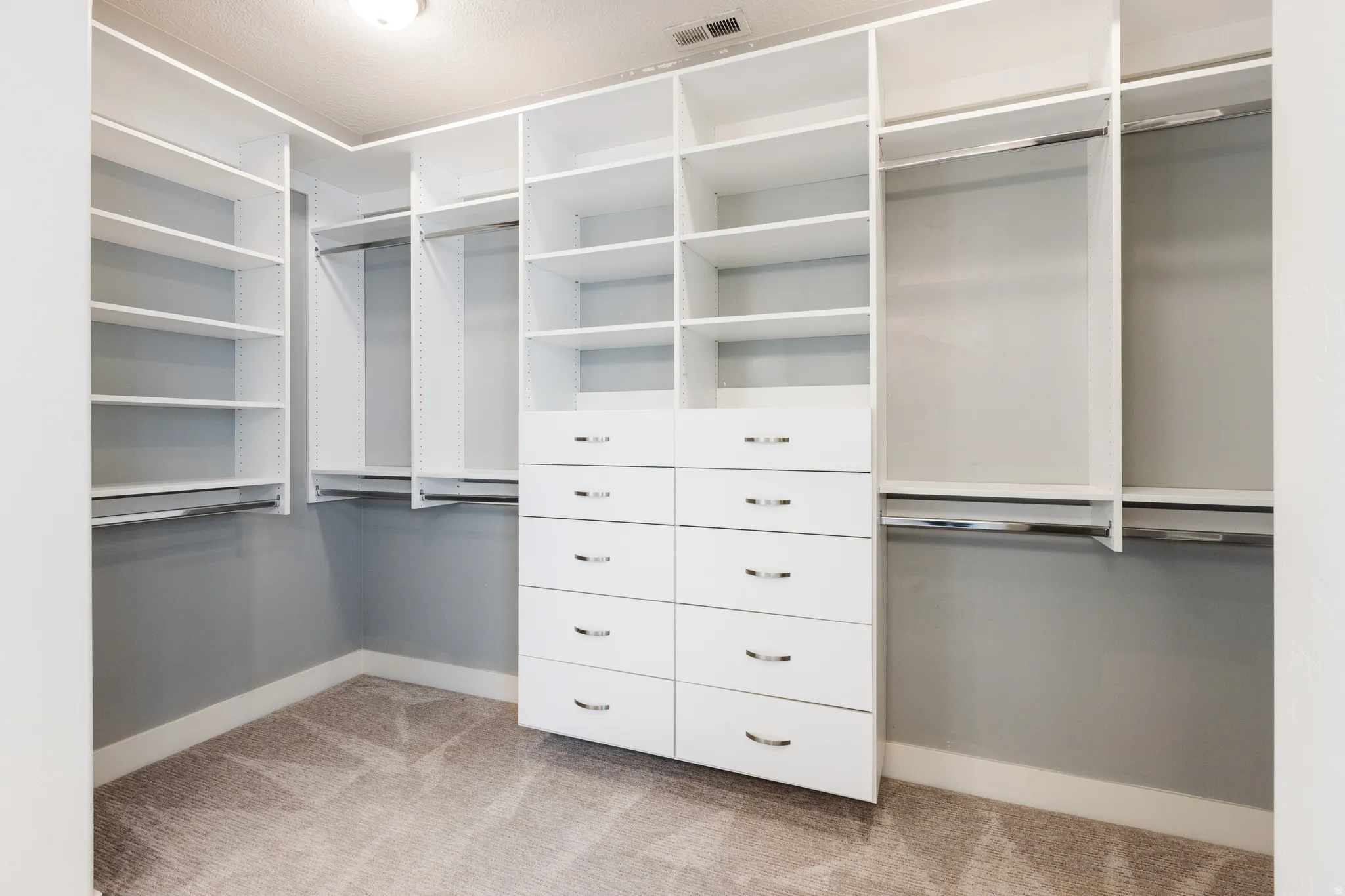 Walk in closet featuring light carpet