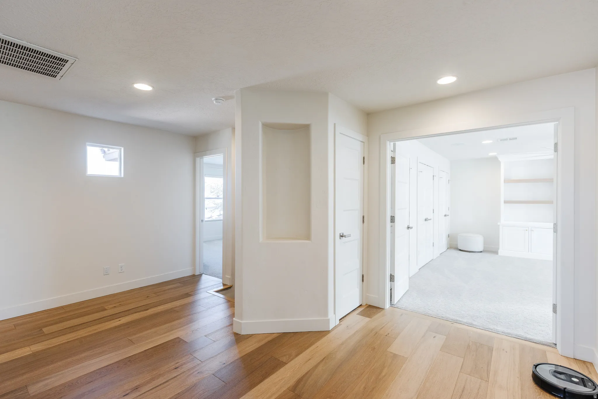 Hall featuring light wood-type flooring and recessed lighting