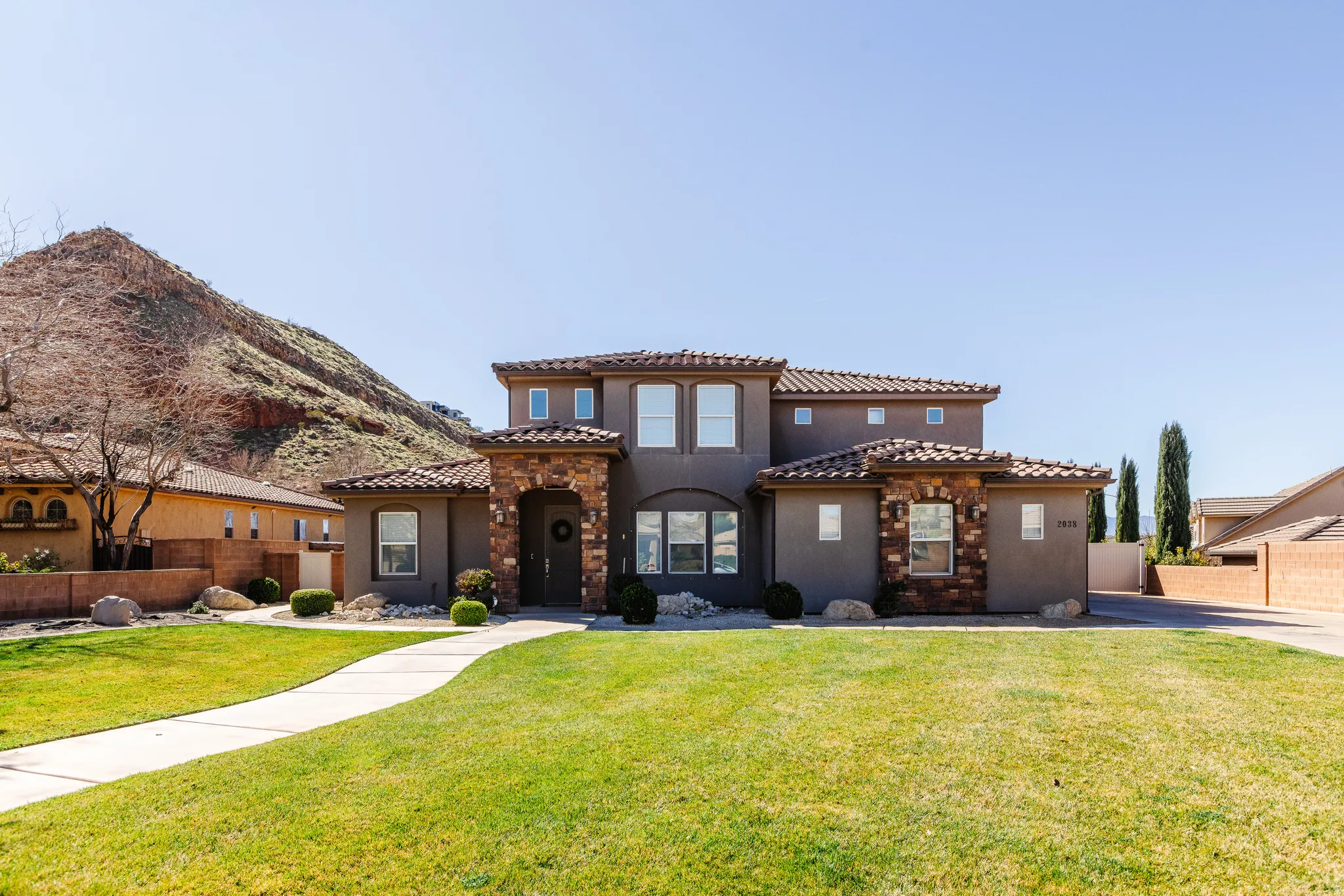 Mediterranean / spanish-style home with stucco siding, a tile roof, and a mountain view