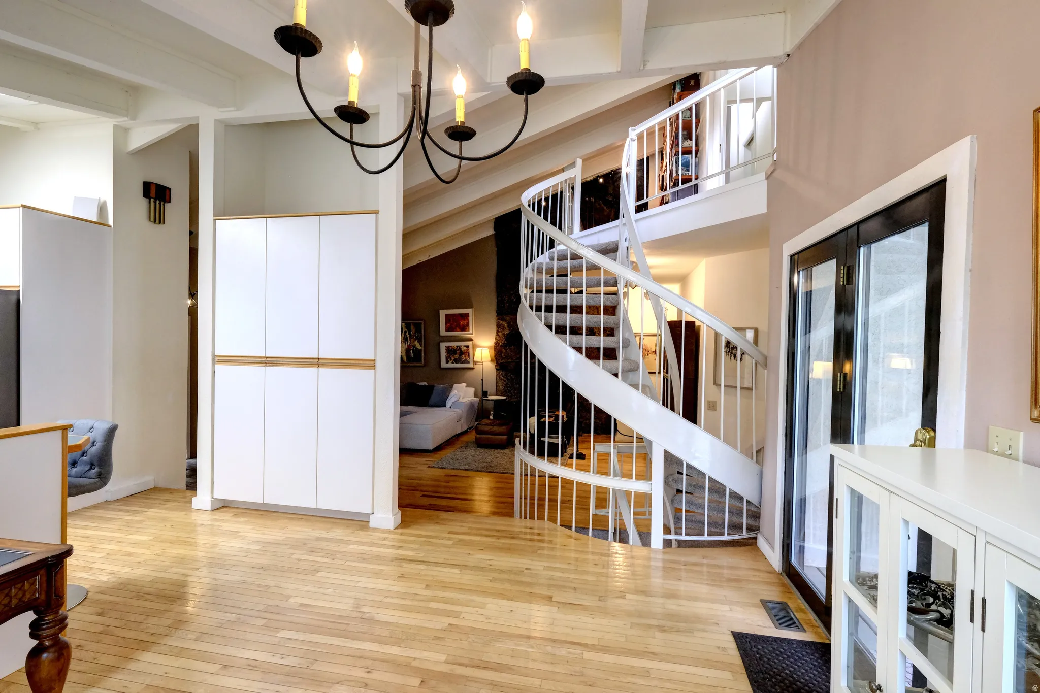 Entryway with light wood-type flooring and hanging lights