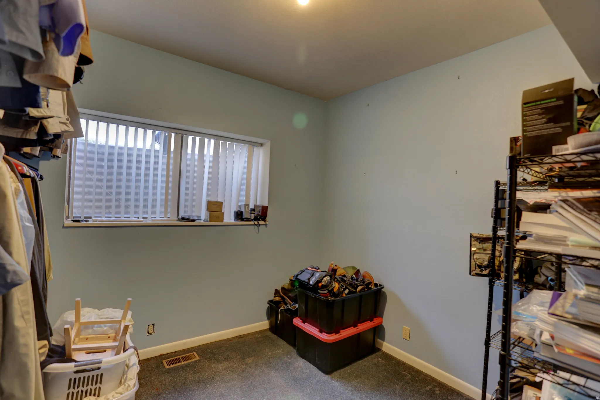Misc room featuring dark carpet and baseboards