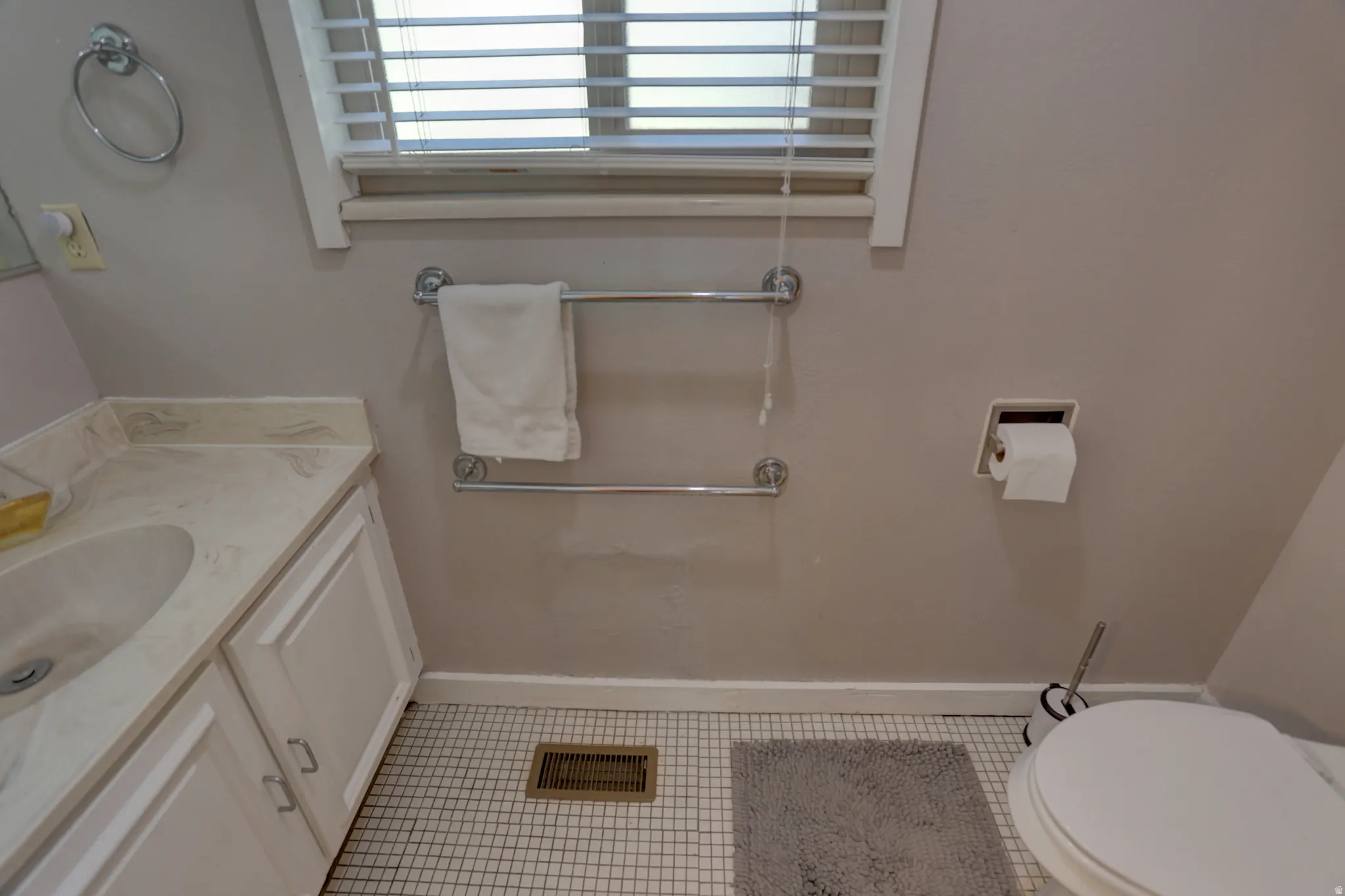 Half bath with vanity and light tile patterned floors
