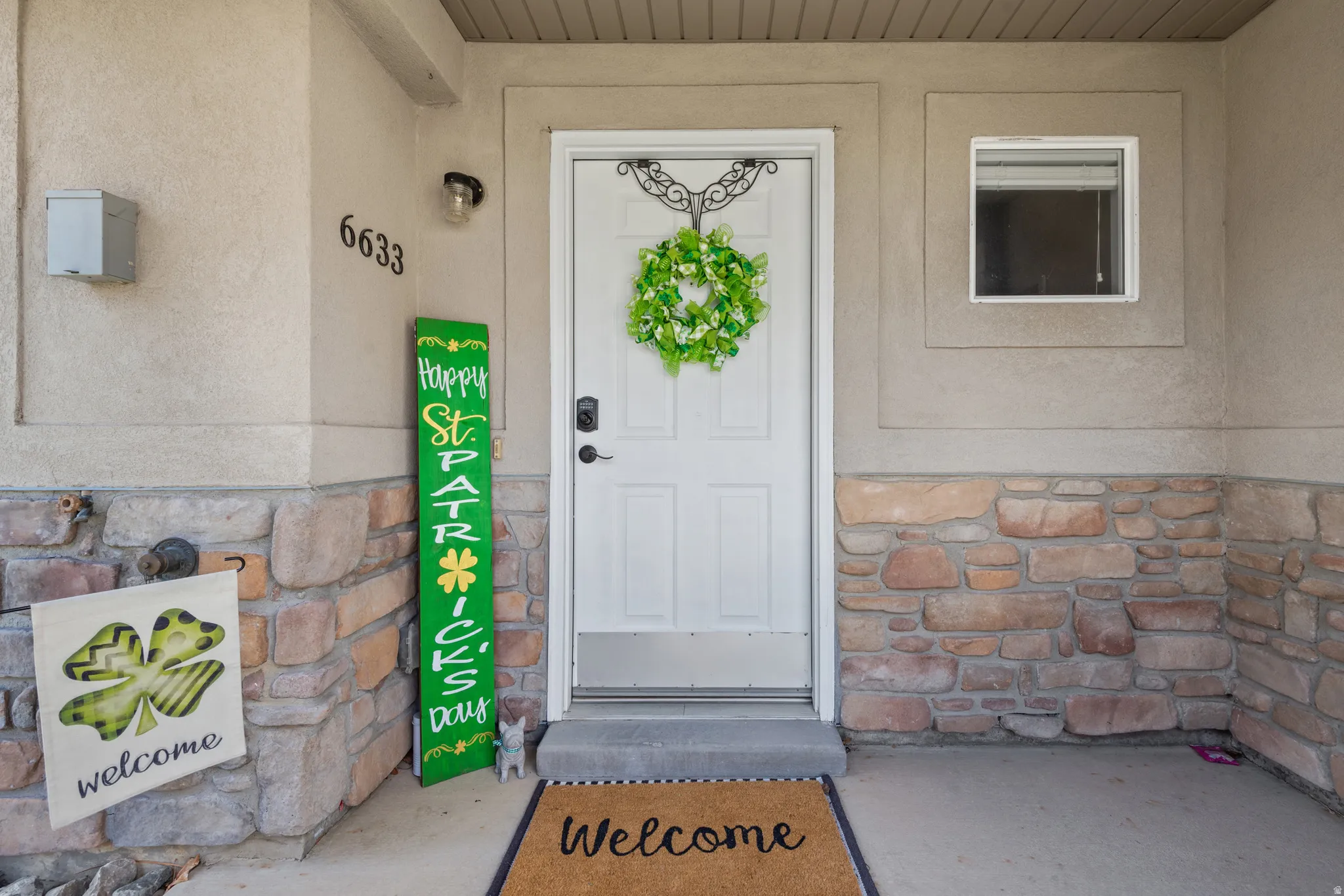 View of exterior entry featuring stone siding