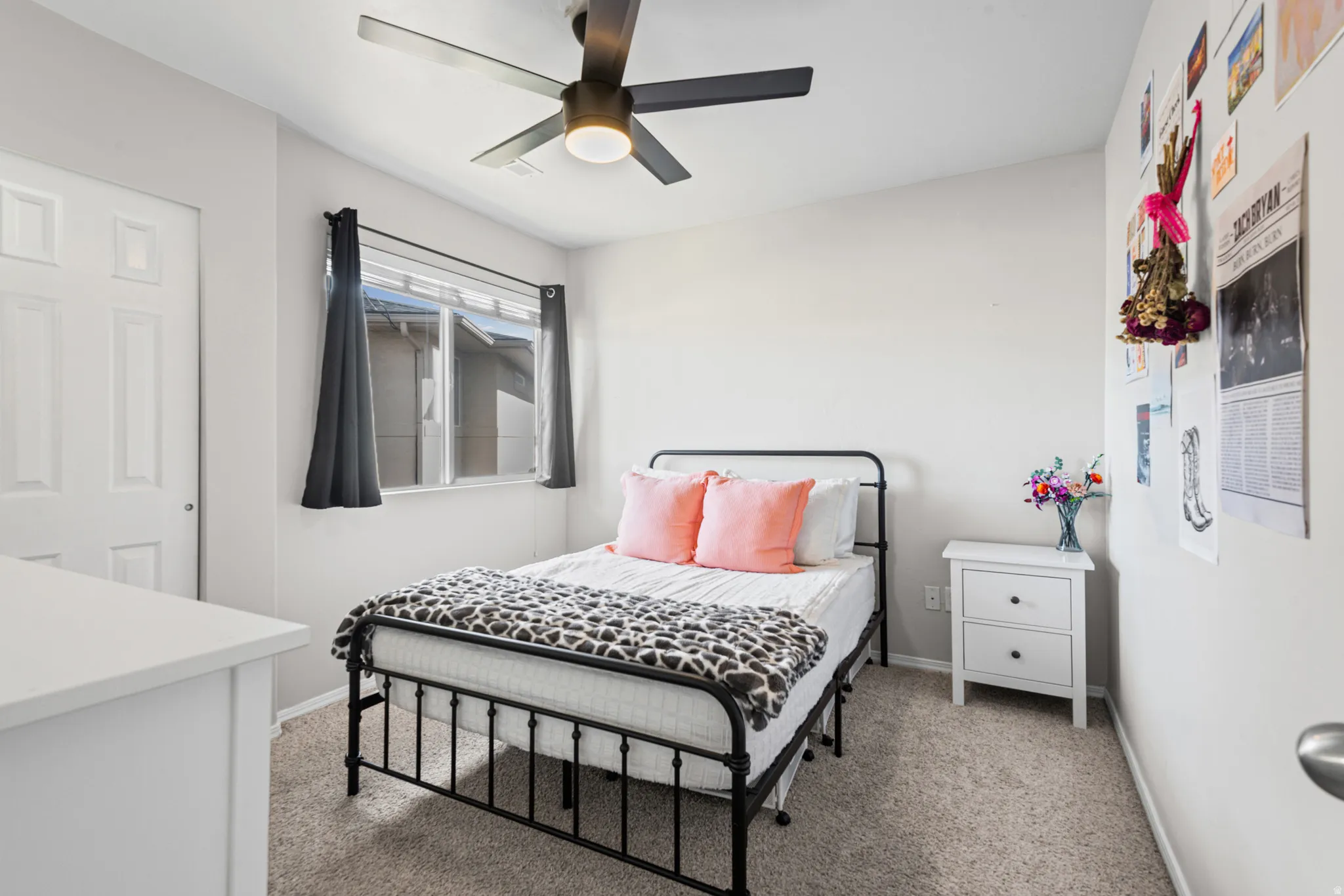 Bedroom with light carpet and ceiling fan