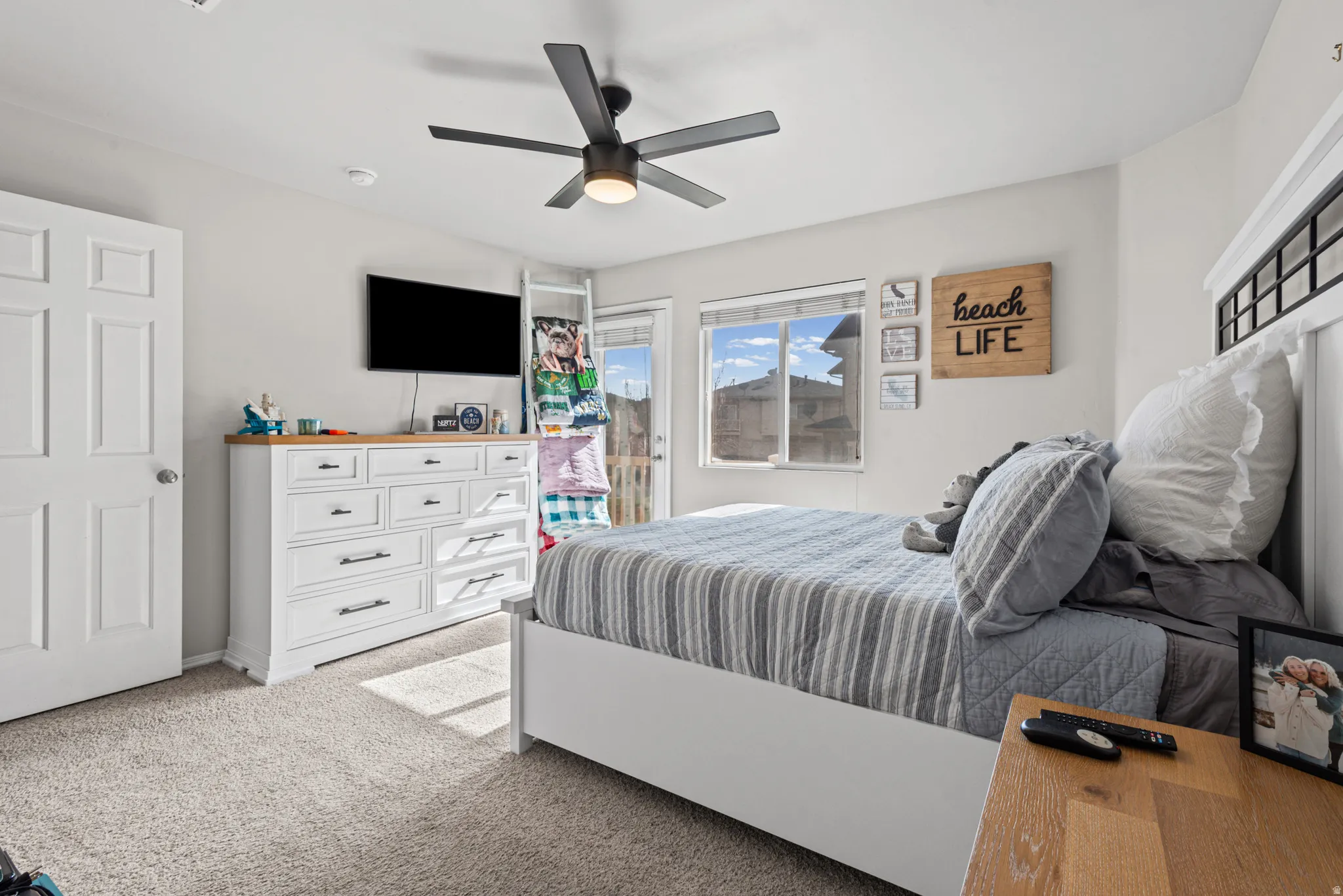 Bedroom featuring access to outside, light carpet, and a ceiling fan