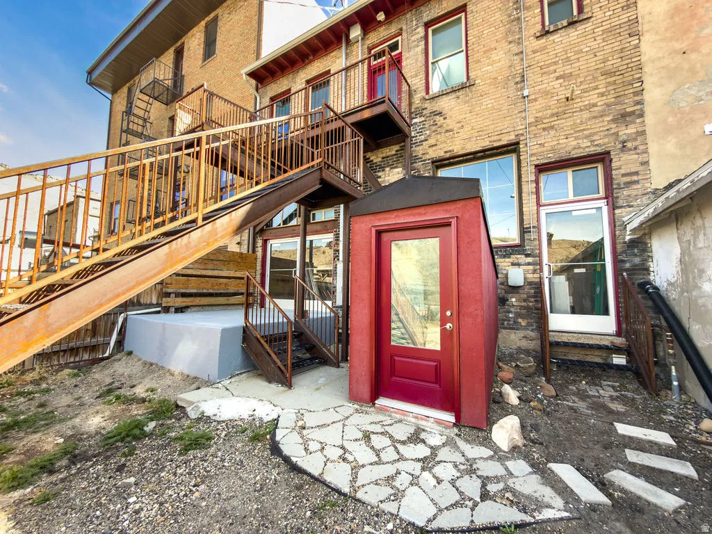 Doorway to property featuring brick siding