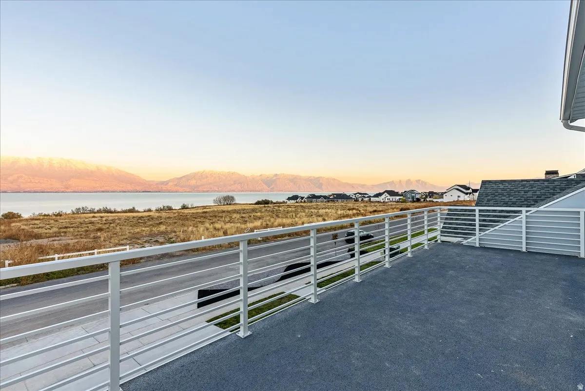 Patio terrace at dusk with a mountain view and a balcony