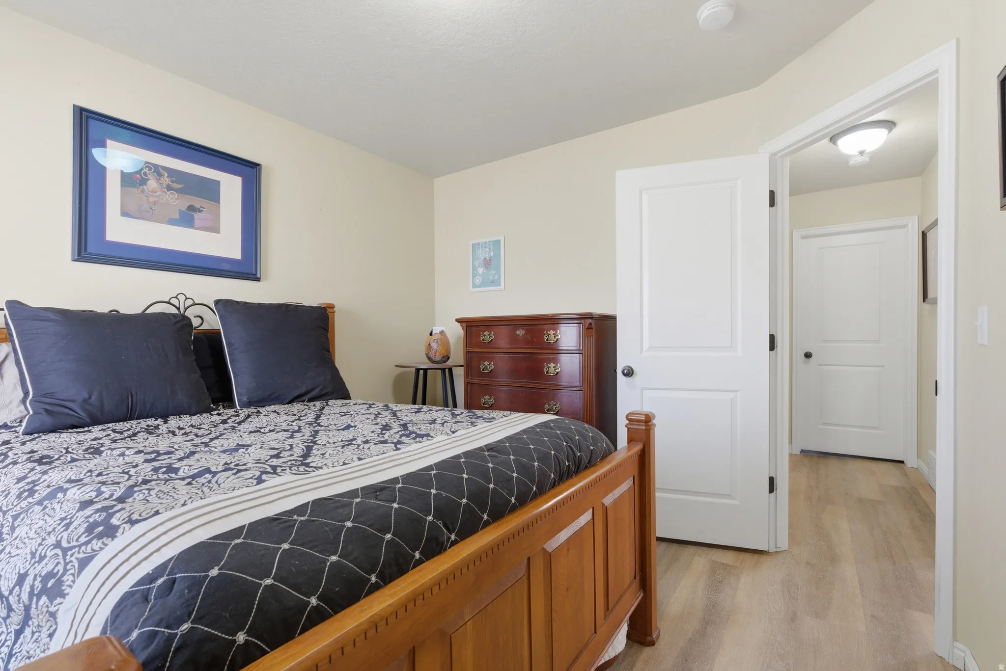 Bedroom featuring LVP flooring and neutral wall tones