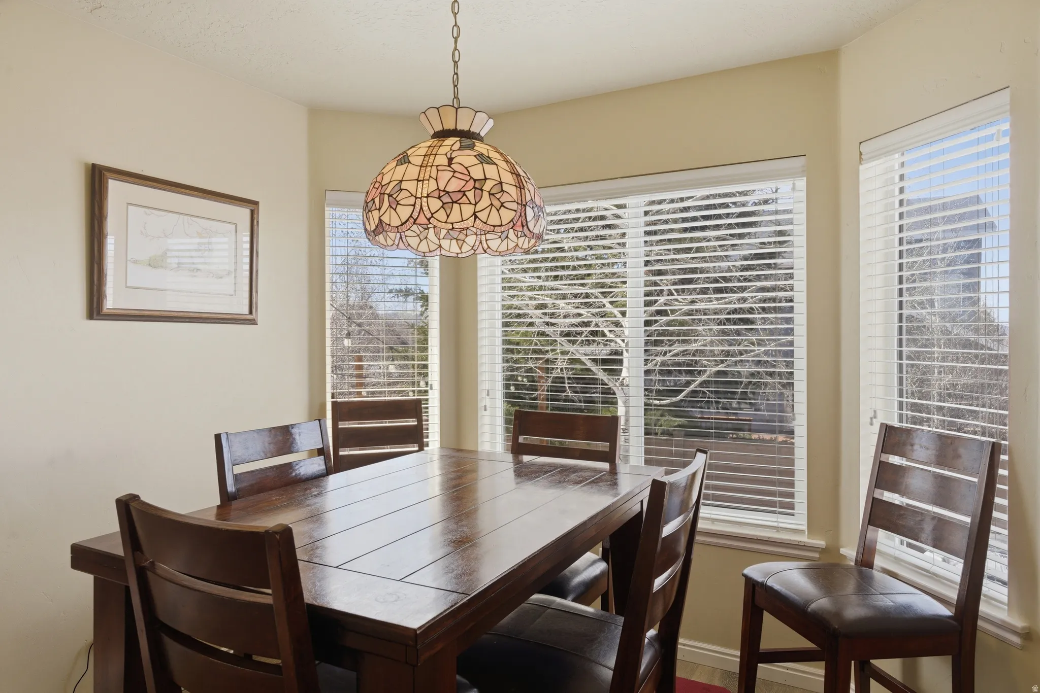 Dining area featuring a bay window,  and neutral-toned walls