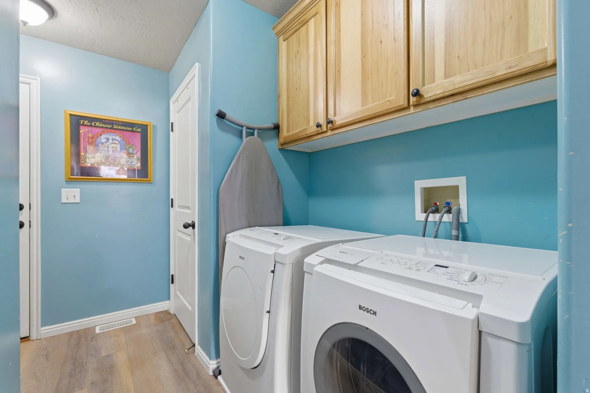 Laundry area featuring overhead storage and Full closet