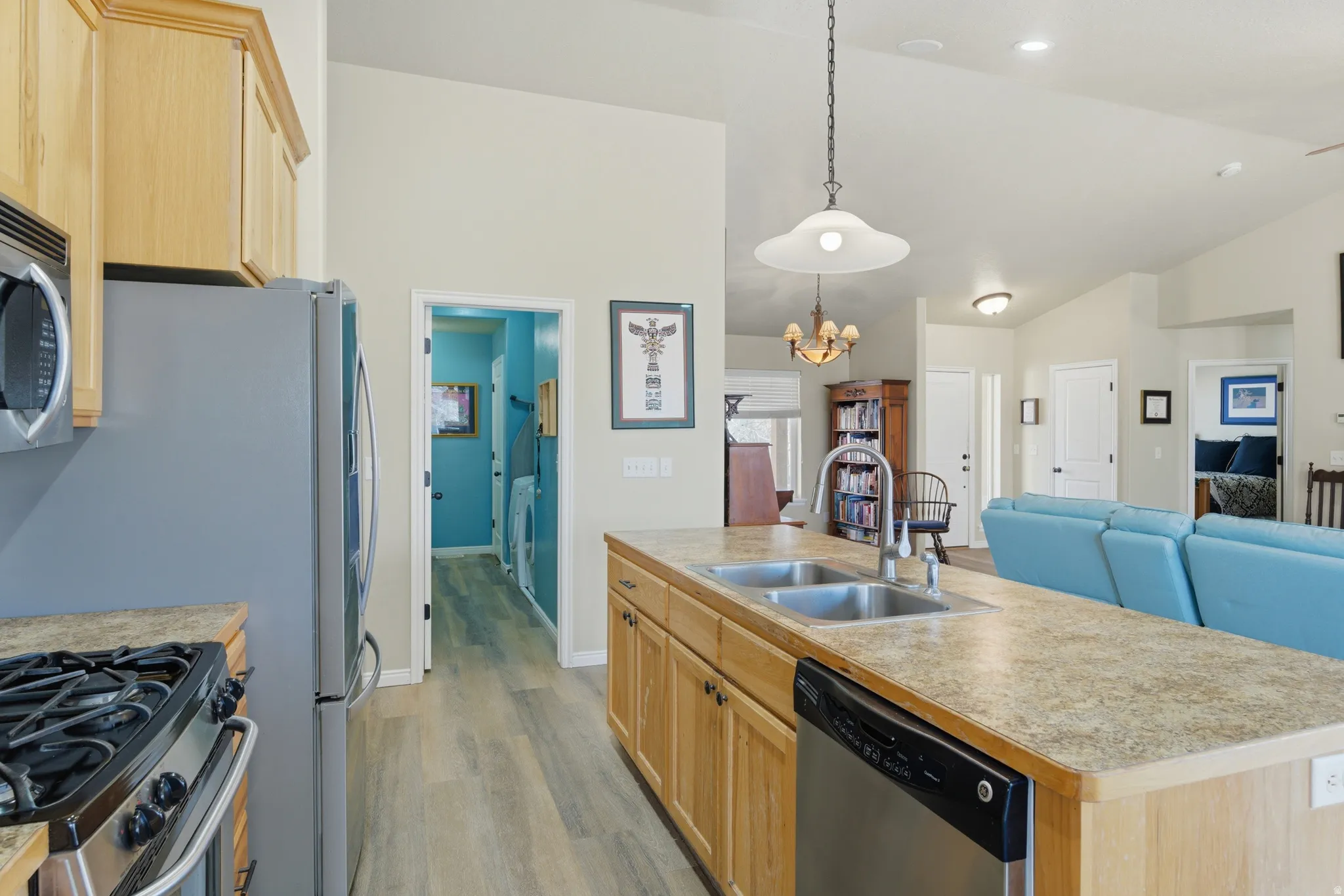 Kitchen island with dual stainless steel sinks and a high-arch faucet