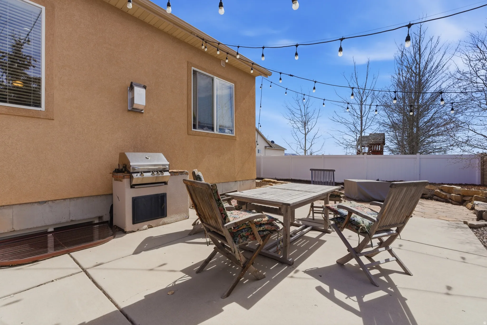 Expansive concrete patio area with built-in barbecue station