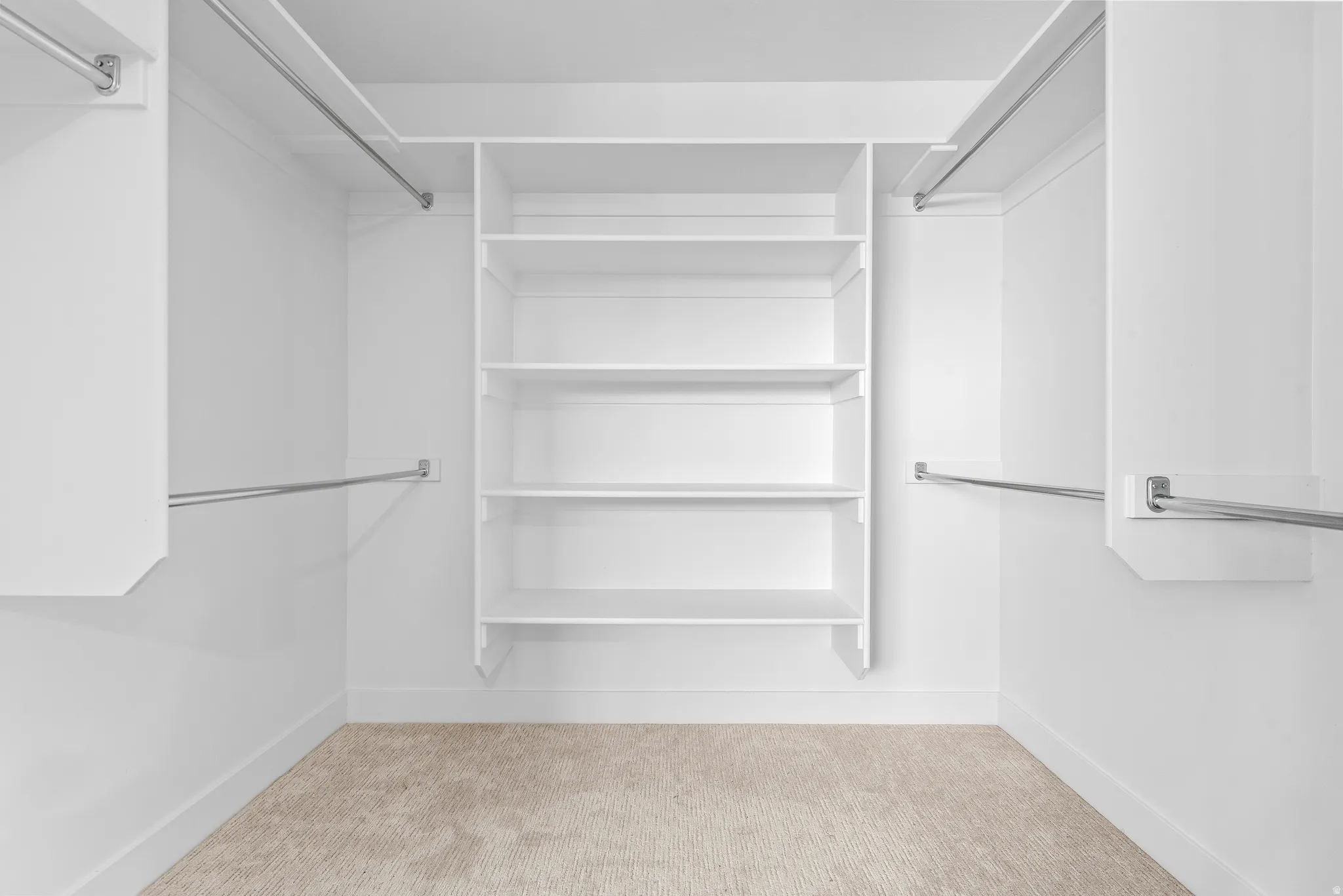 Walk in closet featuring light carpet