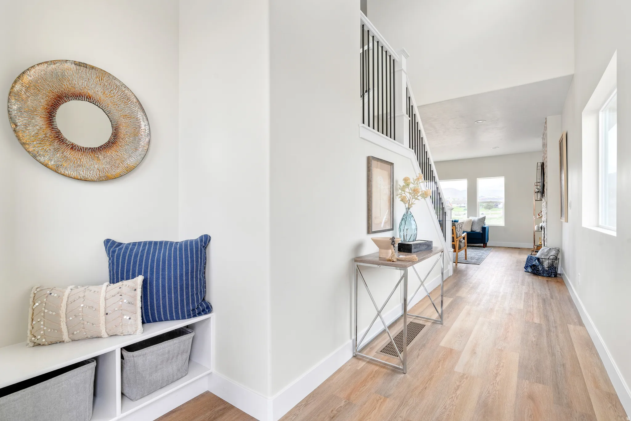Hall with light wood finished floors and baseboards