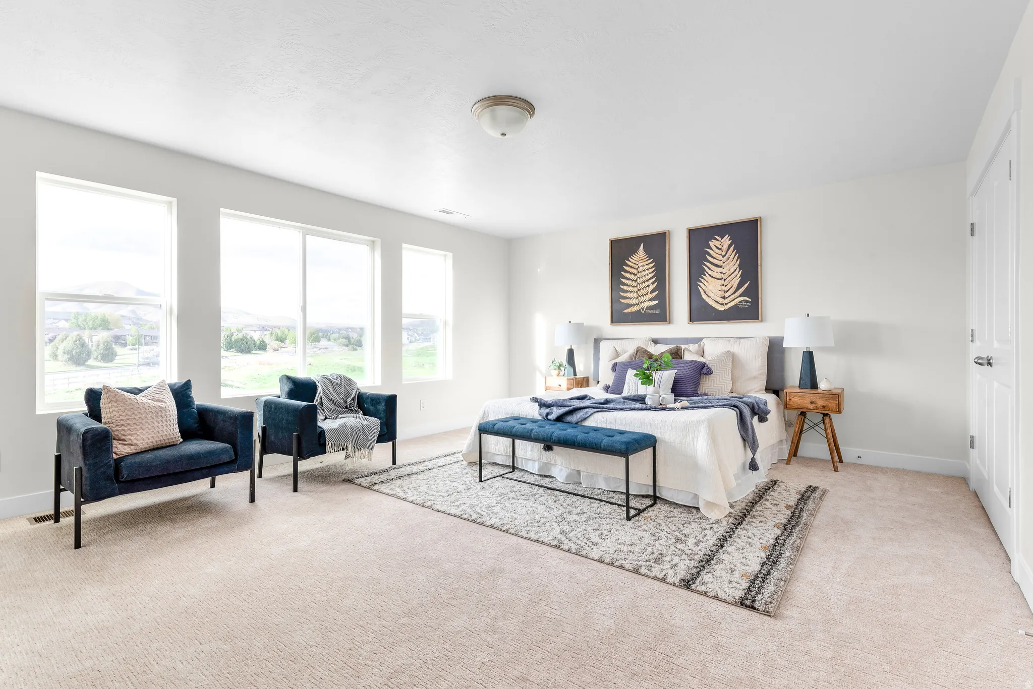 Bedroom with baseboards and light colored carpet