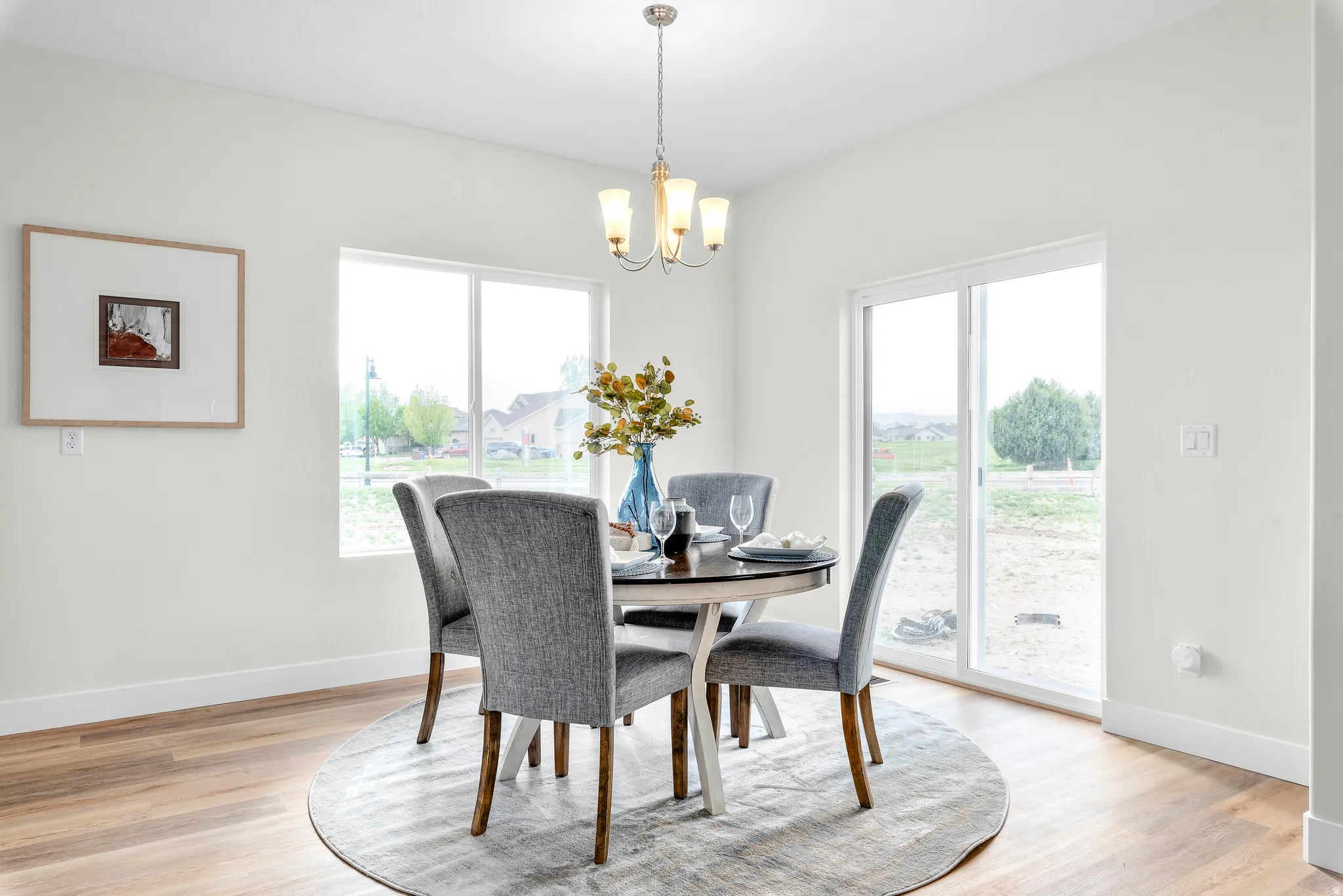 Dining space featuring light wood-style flooring and suspended lighting