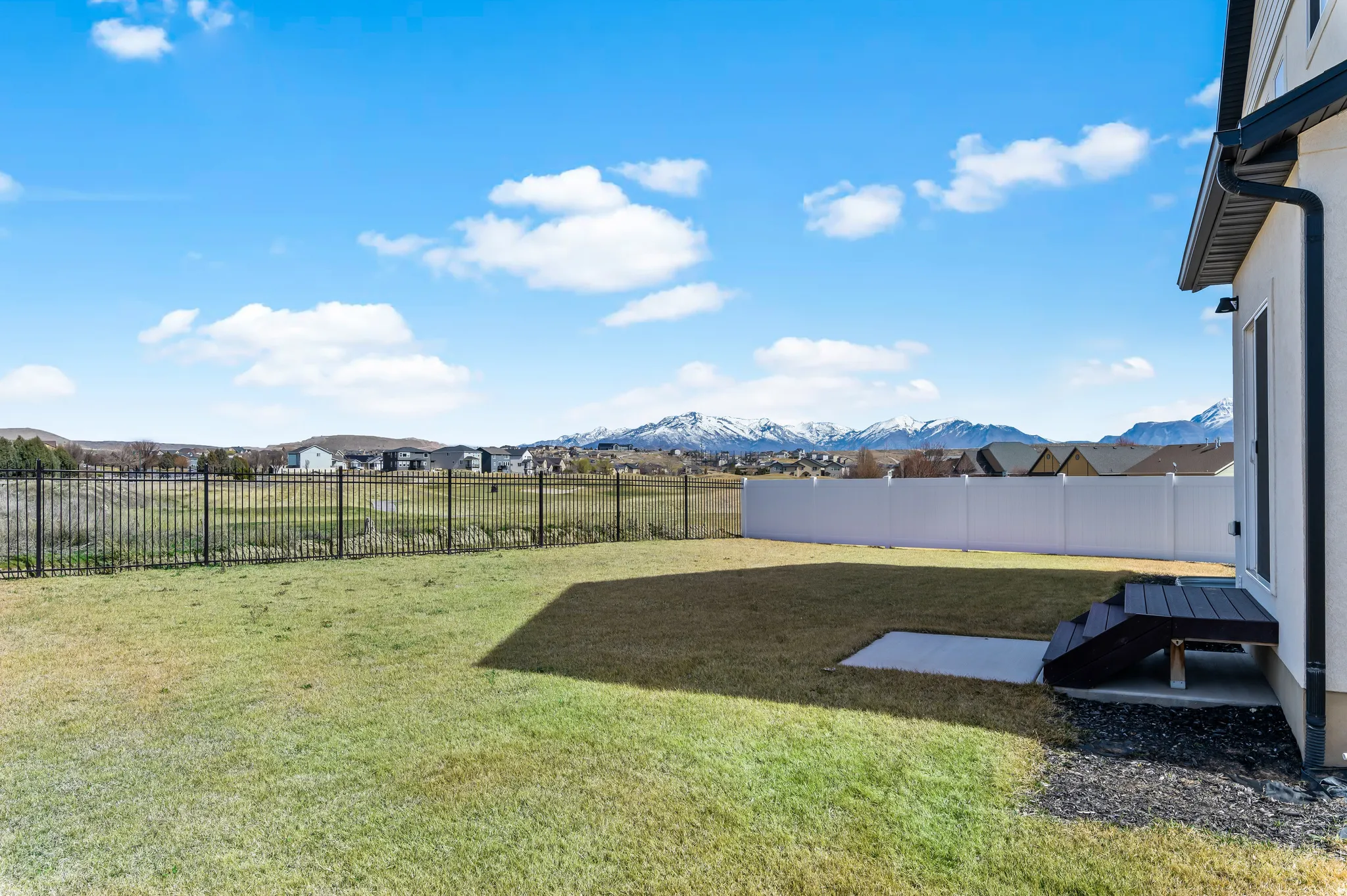 Fenced backyard featuring a patio area and a mountain view