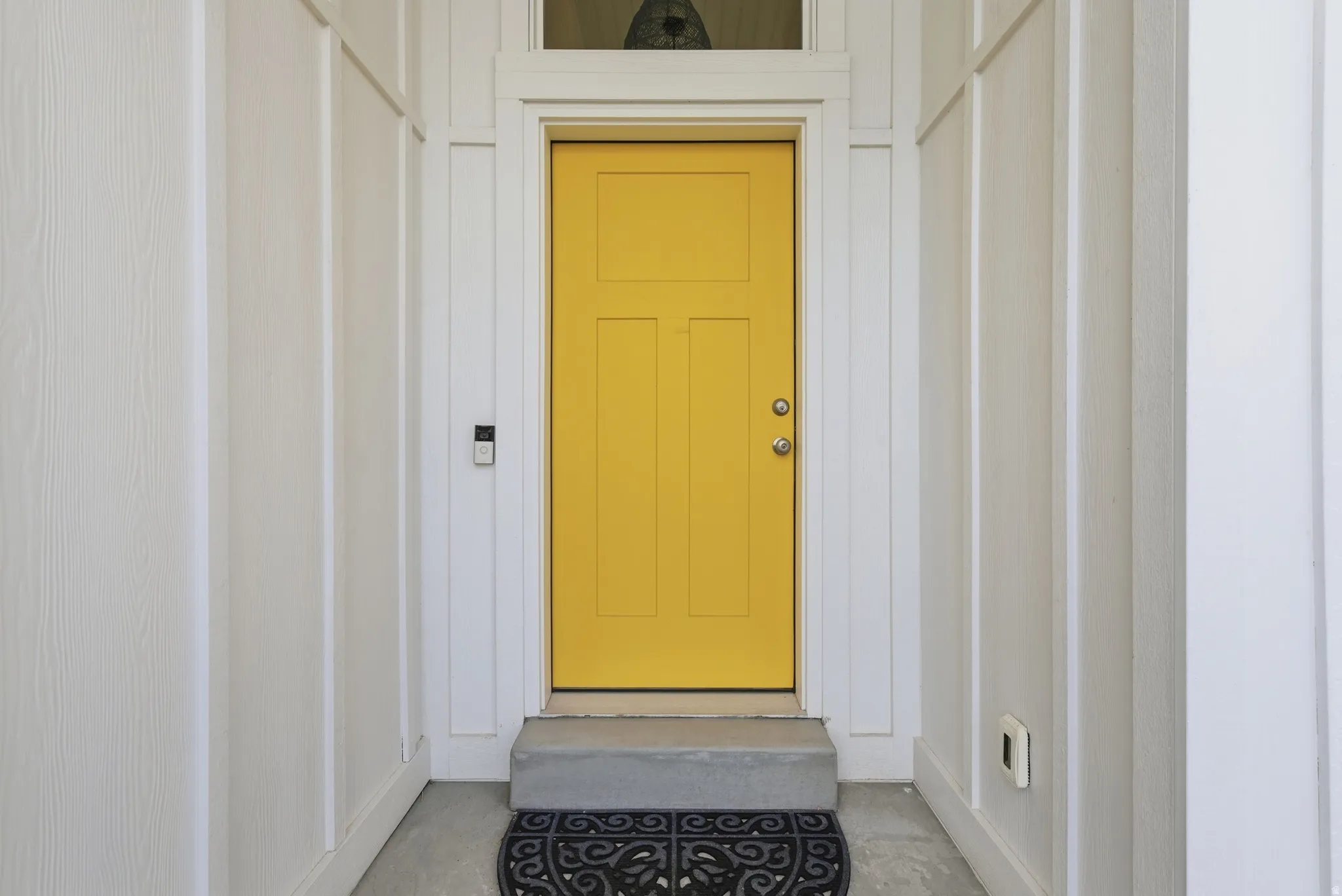 Property entrance featuring board and batten siding