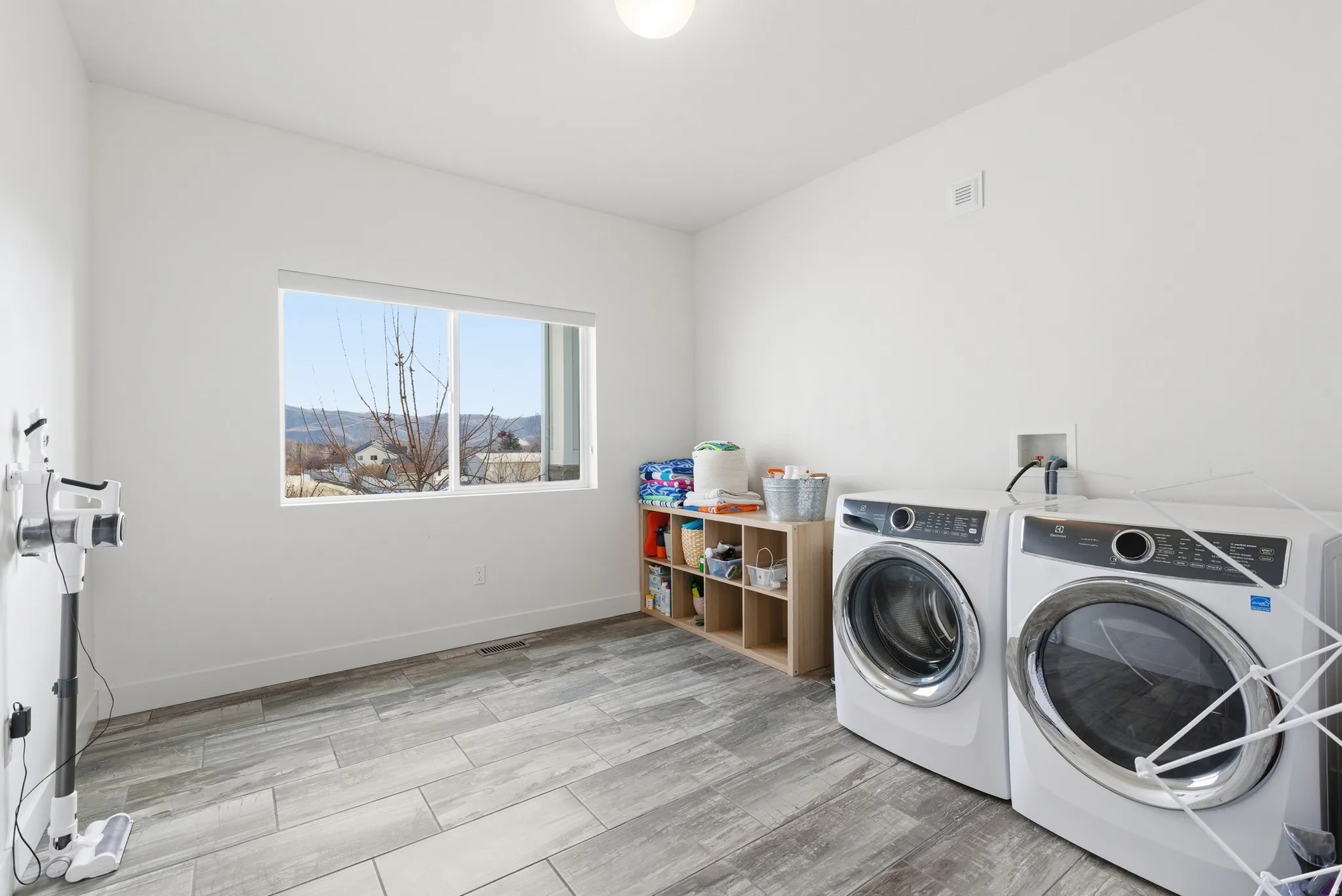Laundry area with wood finish floors and washing machine and clothes dryer