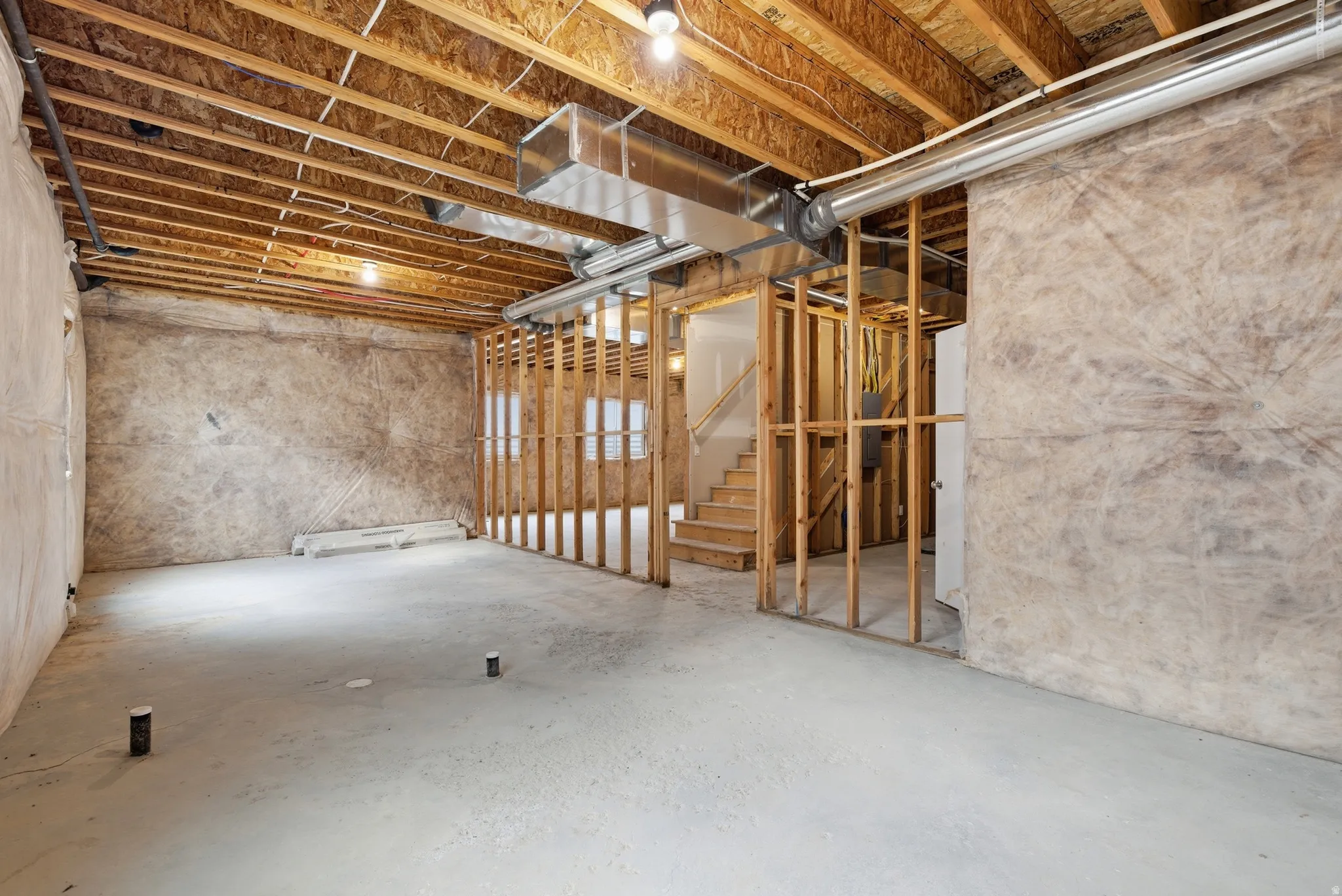 Unfinished basement featuring stairs