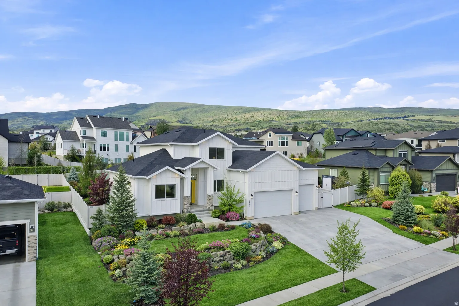 Modern farmhouse featuring a residential view, driveway, and board and batten siding