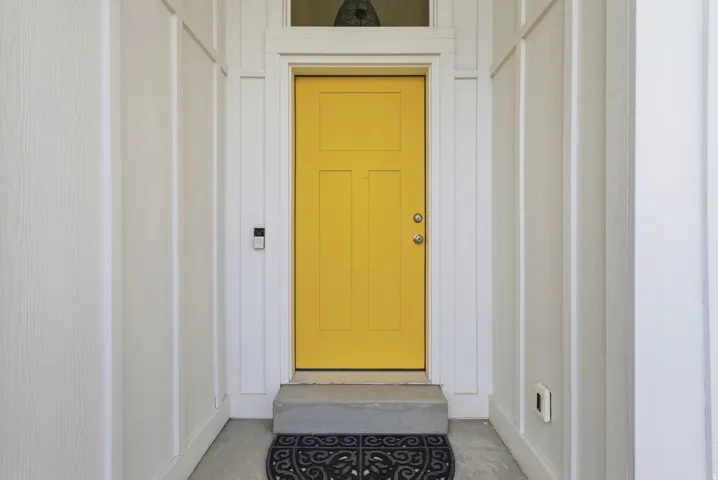 Property entrance featuring board and batten siding