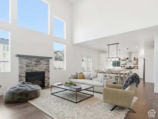 Living area with dark wood finished floors, a fireplace, and recessed lighting