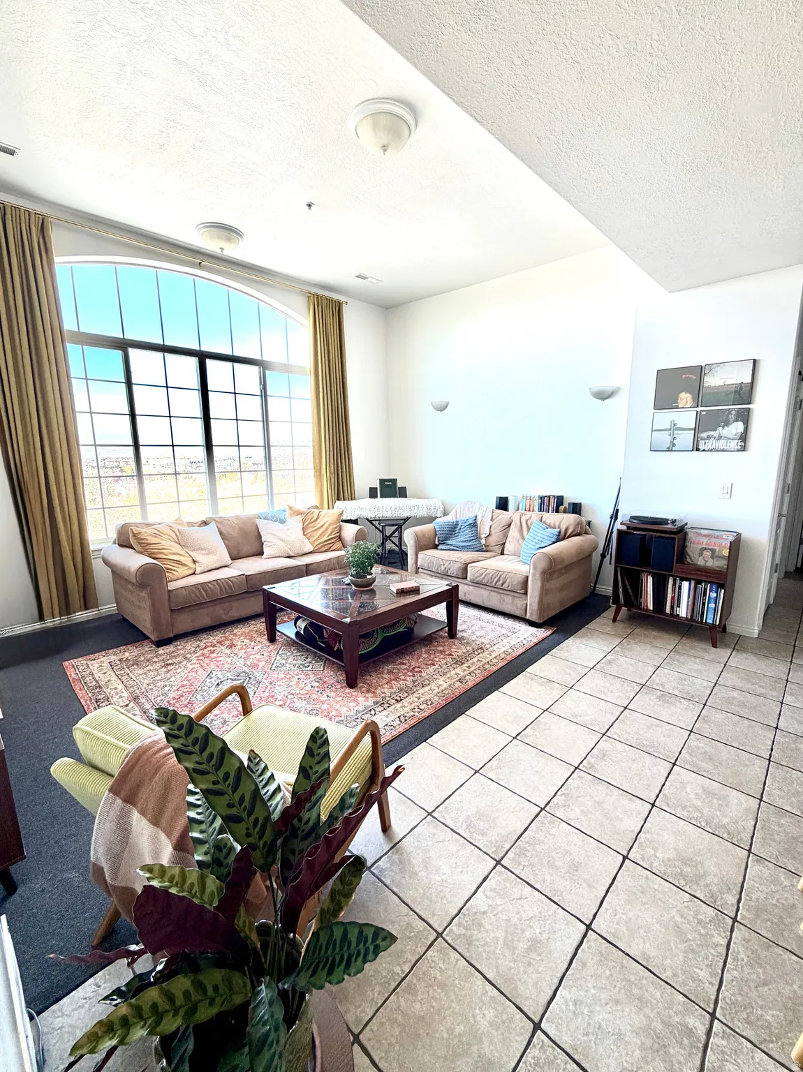 Tiled living room with a textured ceiling
