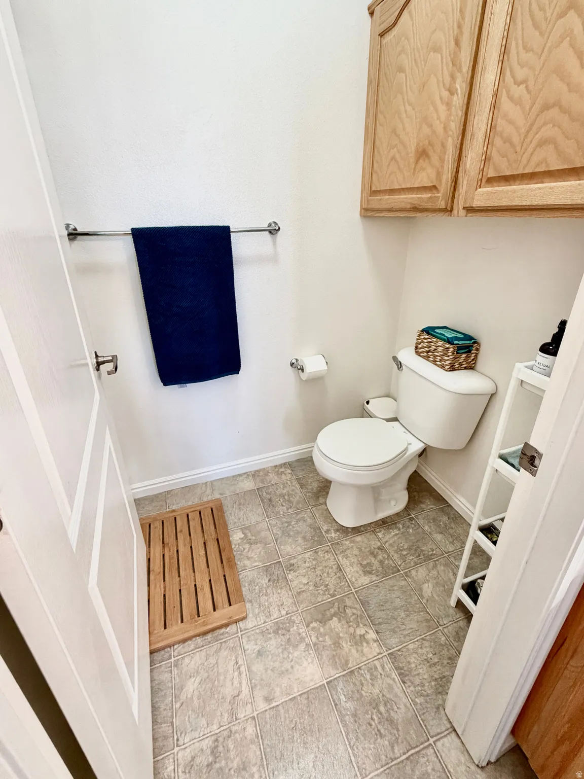 Bathroom with toilet and baseboards