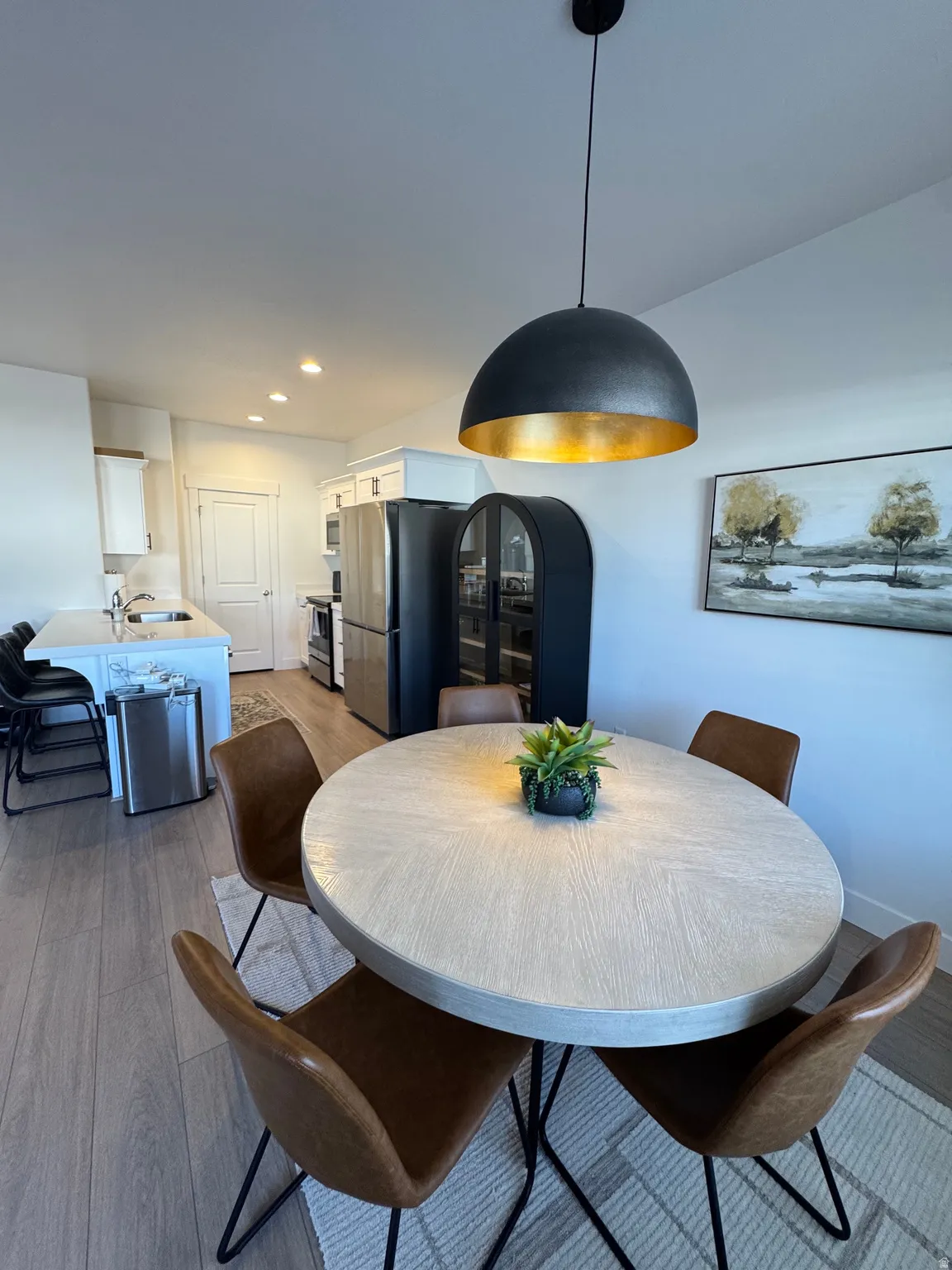 Dining space featuring light wood-style flooring and recessed lighting