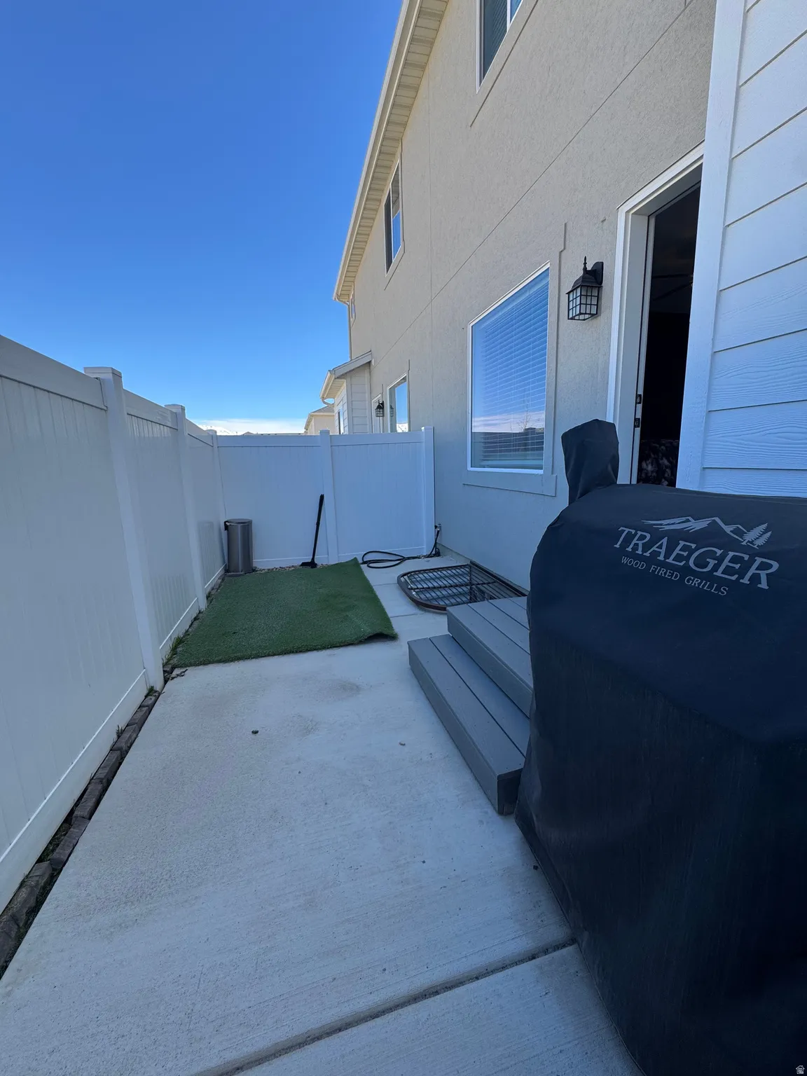 Fenced backyard featuring a deck