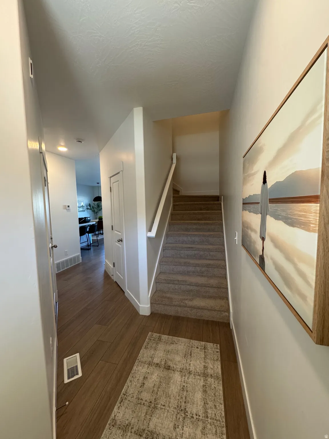 Stairway featuring baseboards and wood finished floors
