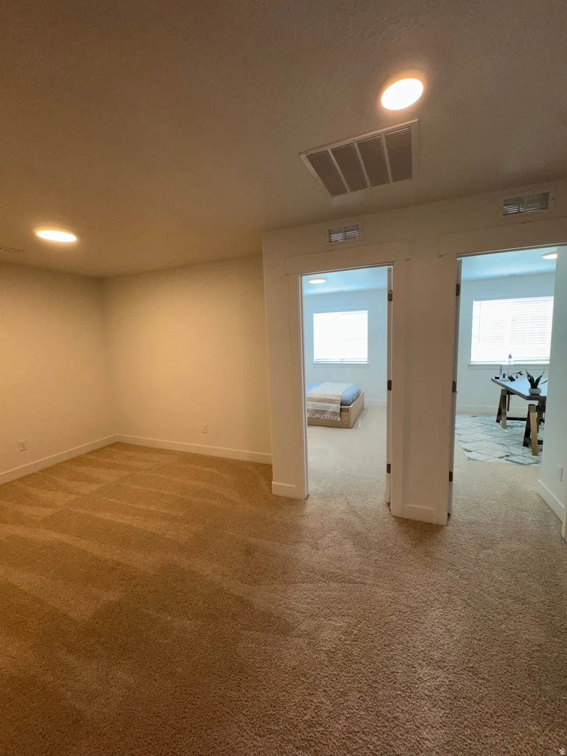 Carpeted empty room featuring baseboards and recessed lighting