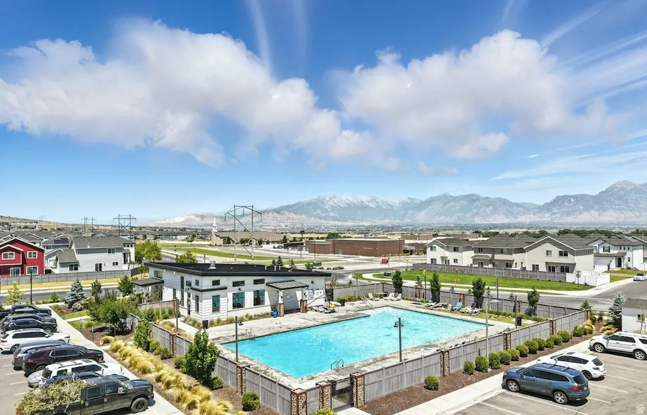 Community pool with a mountain view and a residential view