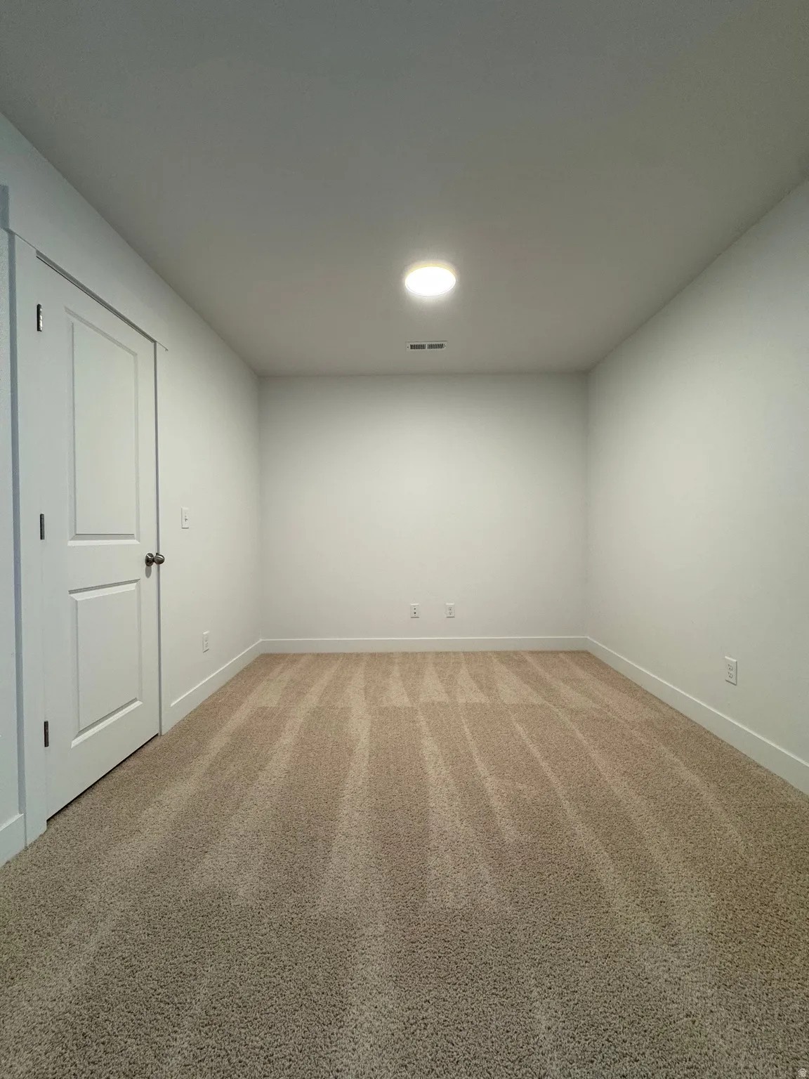 Unfurnished room with light carpet and baseboards