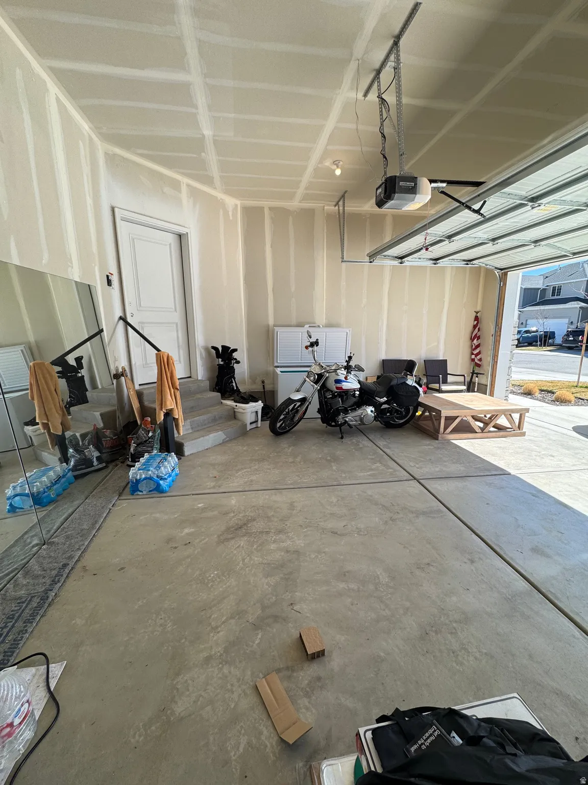 Garage with white fridge and a garage door opener