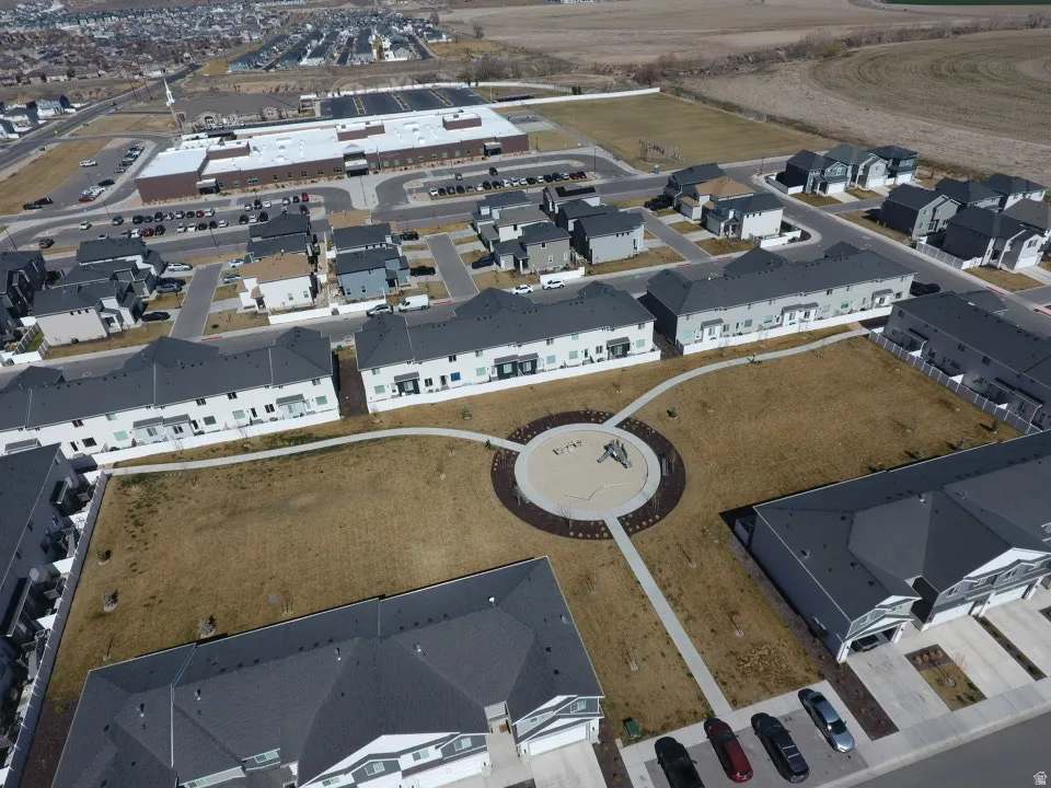 Aerial view of property and surrounding area featuring nearby suburban area