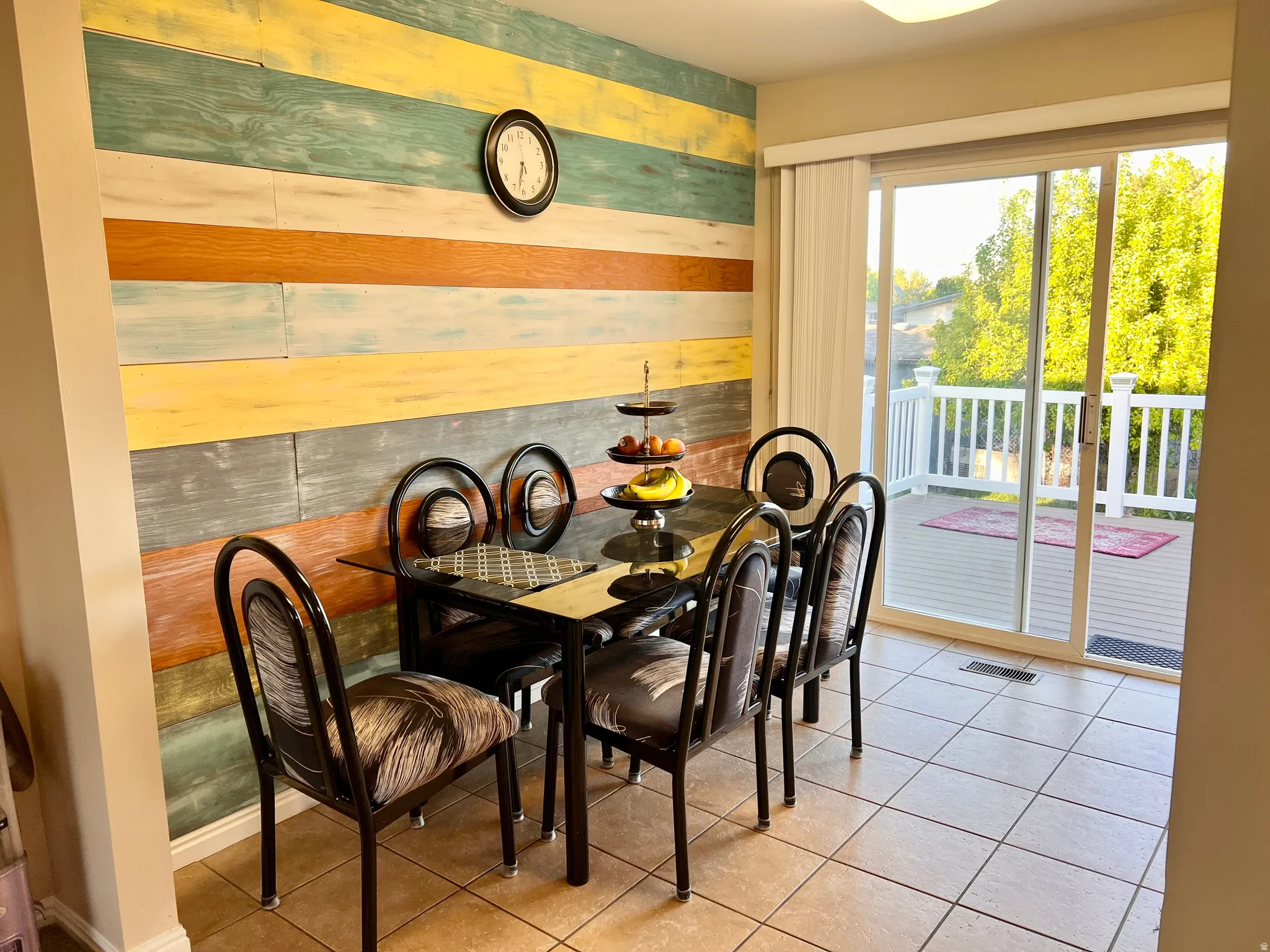 Dining room featuring tile patterned floors and wood walls