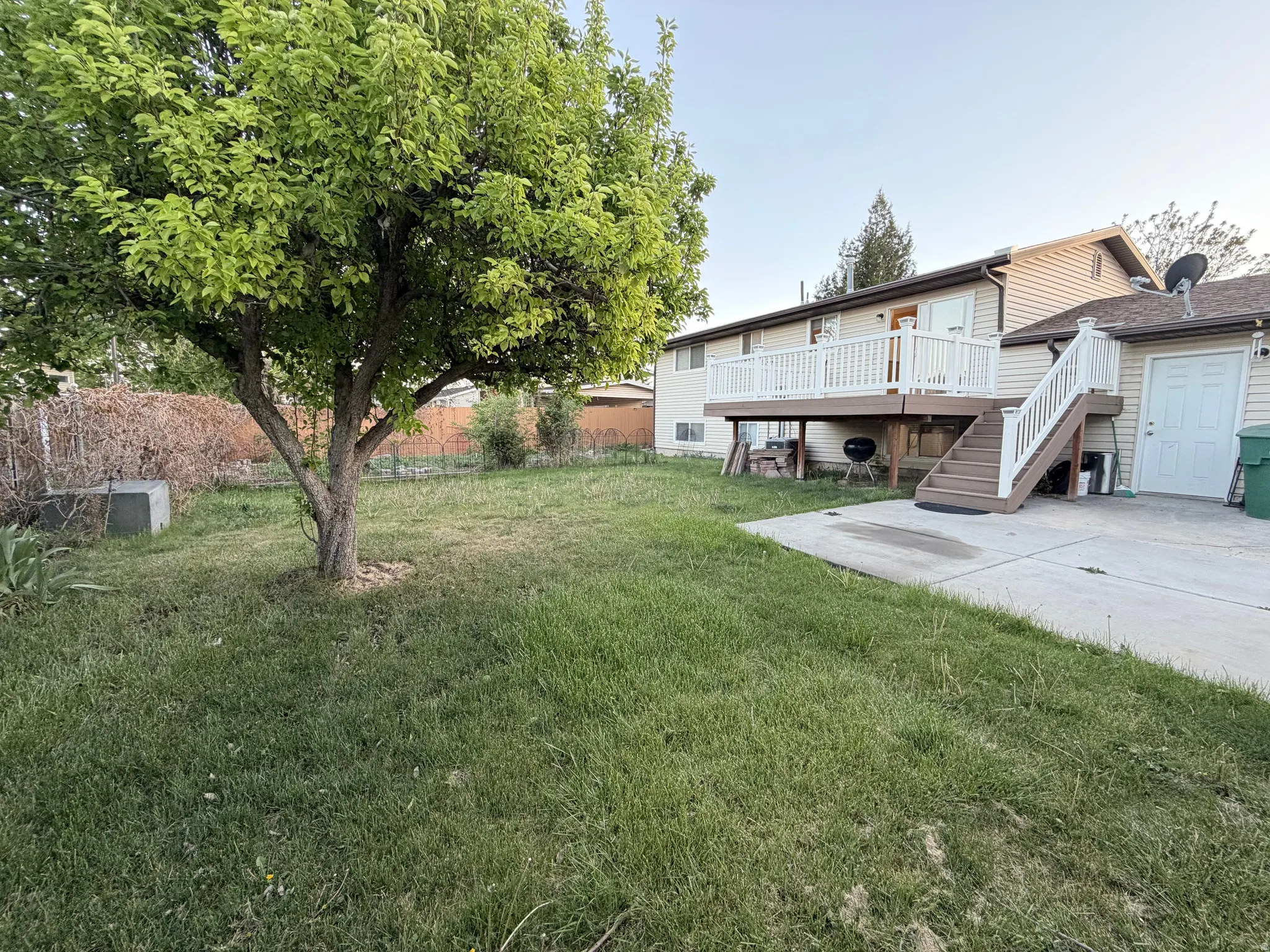 View of yard with a wooden deck and stairs
