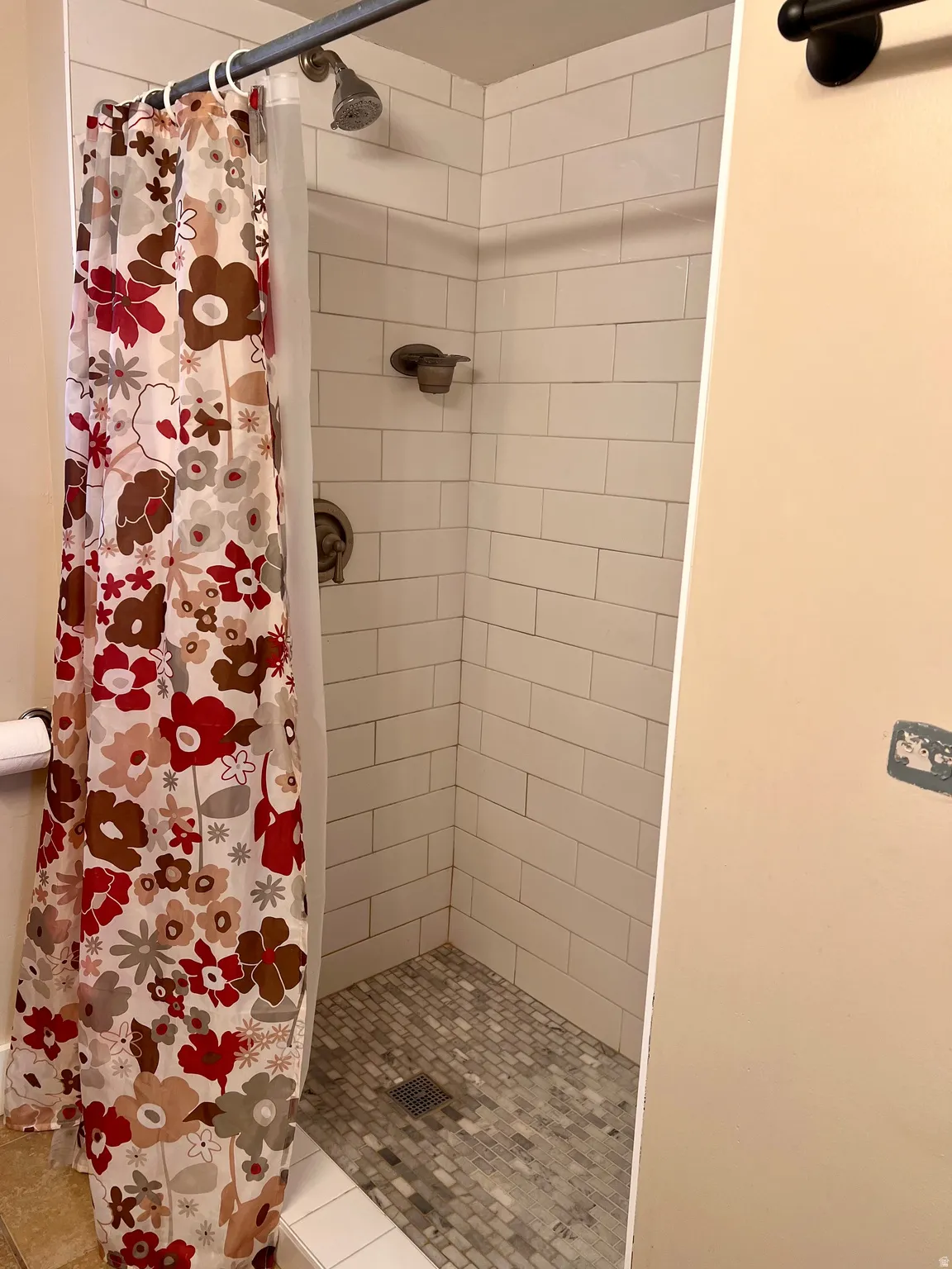 Full bathroom featuring a stall shower and toilet