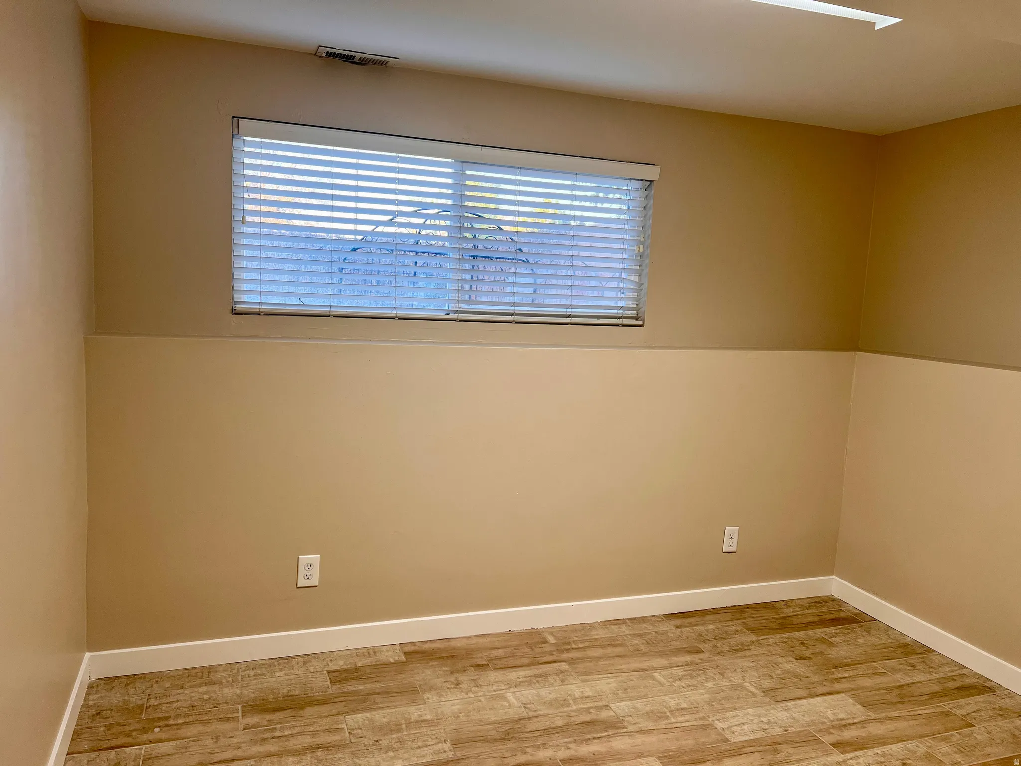 Spare room with light wood finished floors and healthy amount of natural light