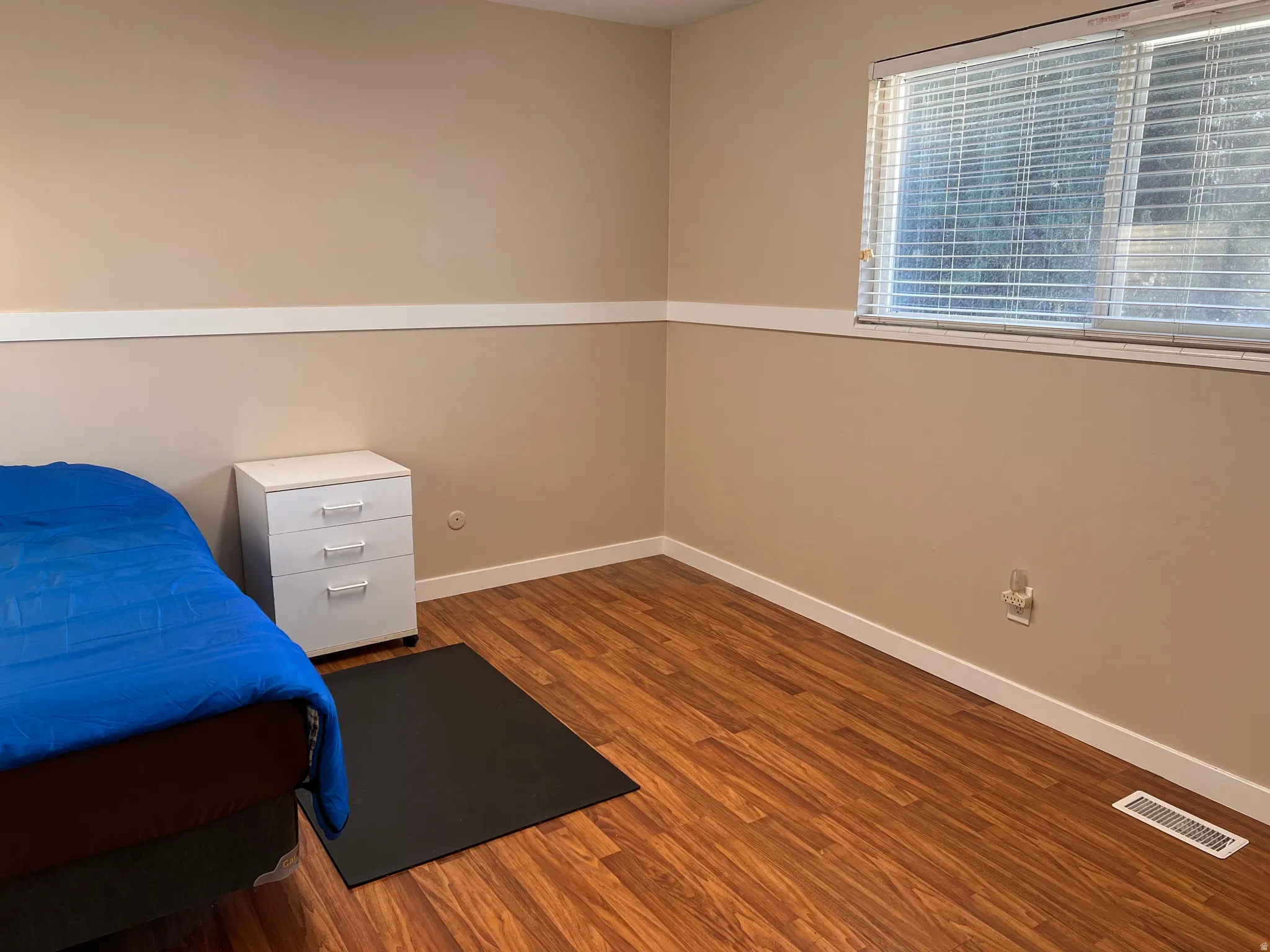 Bedroom with baseboards and dark wood-style floors