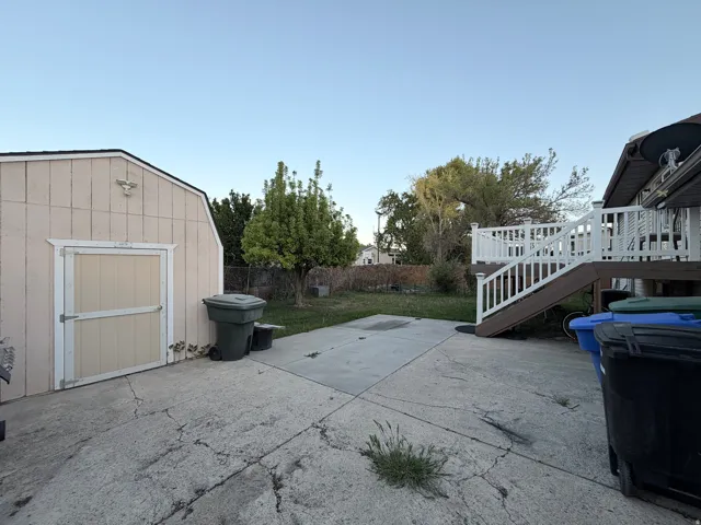 View of patio / terrace featuring a shed and a deck