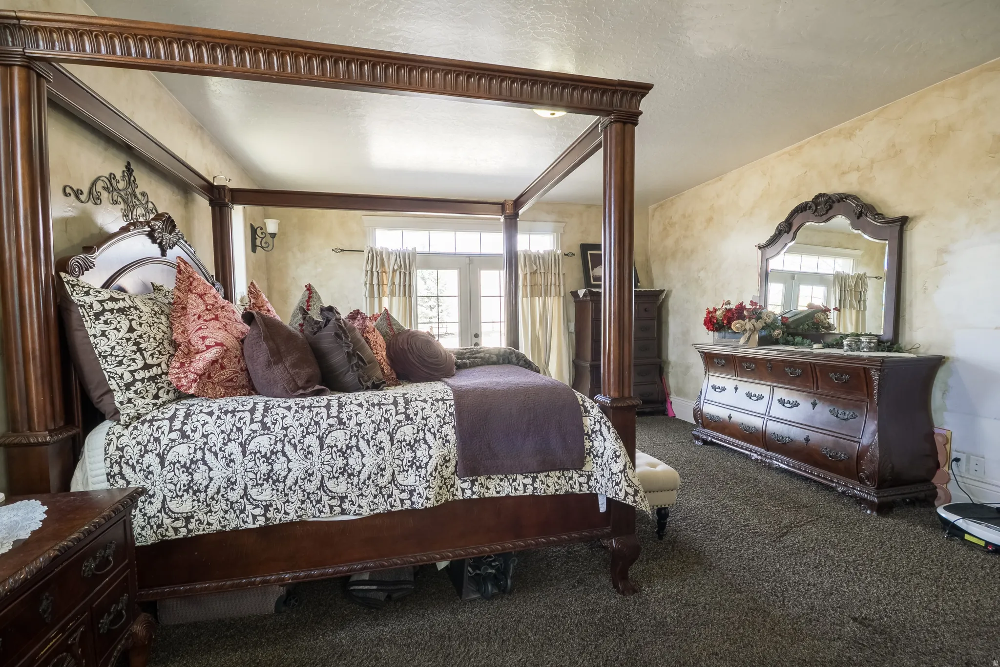 Bedroom featuring dark carpet and a textured ceiling
