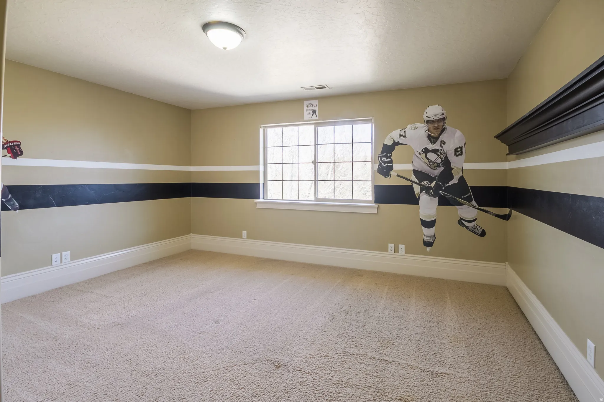 Spare room featuring light colored carpet and a textured ceiling