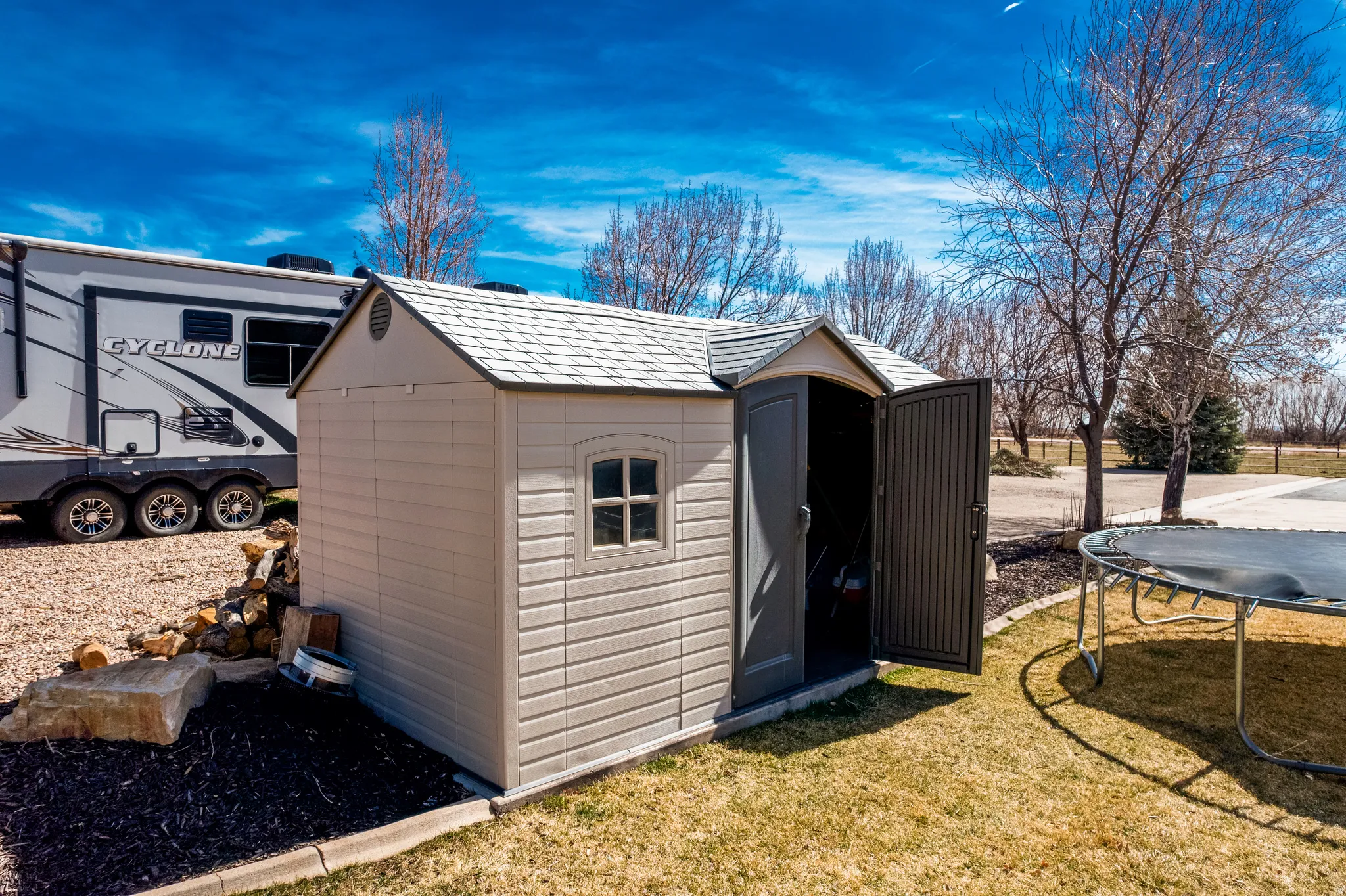 View of shed with a trampoline
