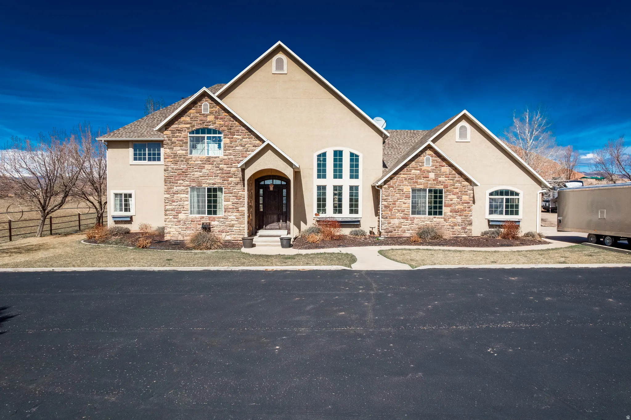 View of front of house with stone siding and stucco siding