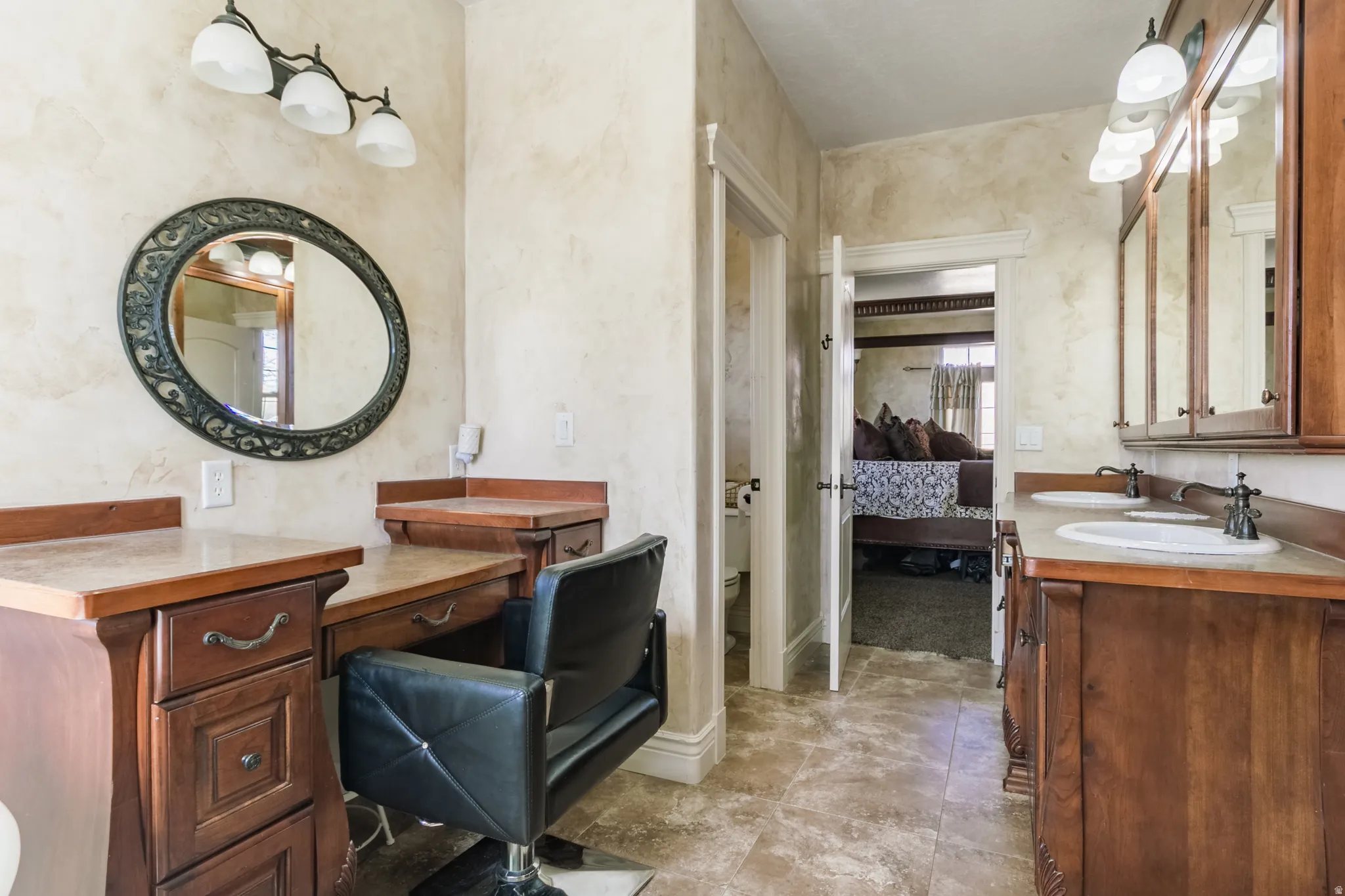 Bathroom featuring double vanity and ensuite bathroom